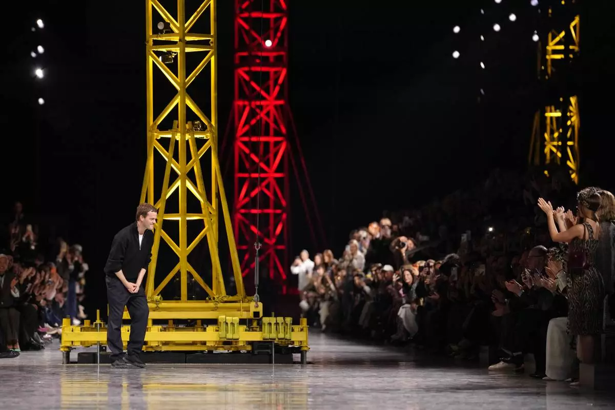 Designer Matthieu Blazy accepts applause after presenting the Chanel Fall/Winter 2026-2027 Women's collection in Paris, Monday, March 9, 2026. (AP Photo/Aurelien Morissard)