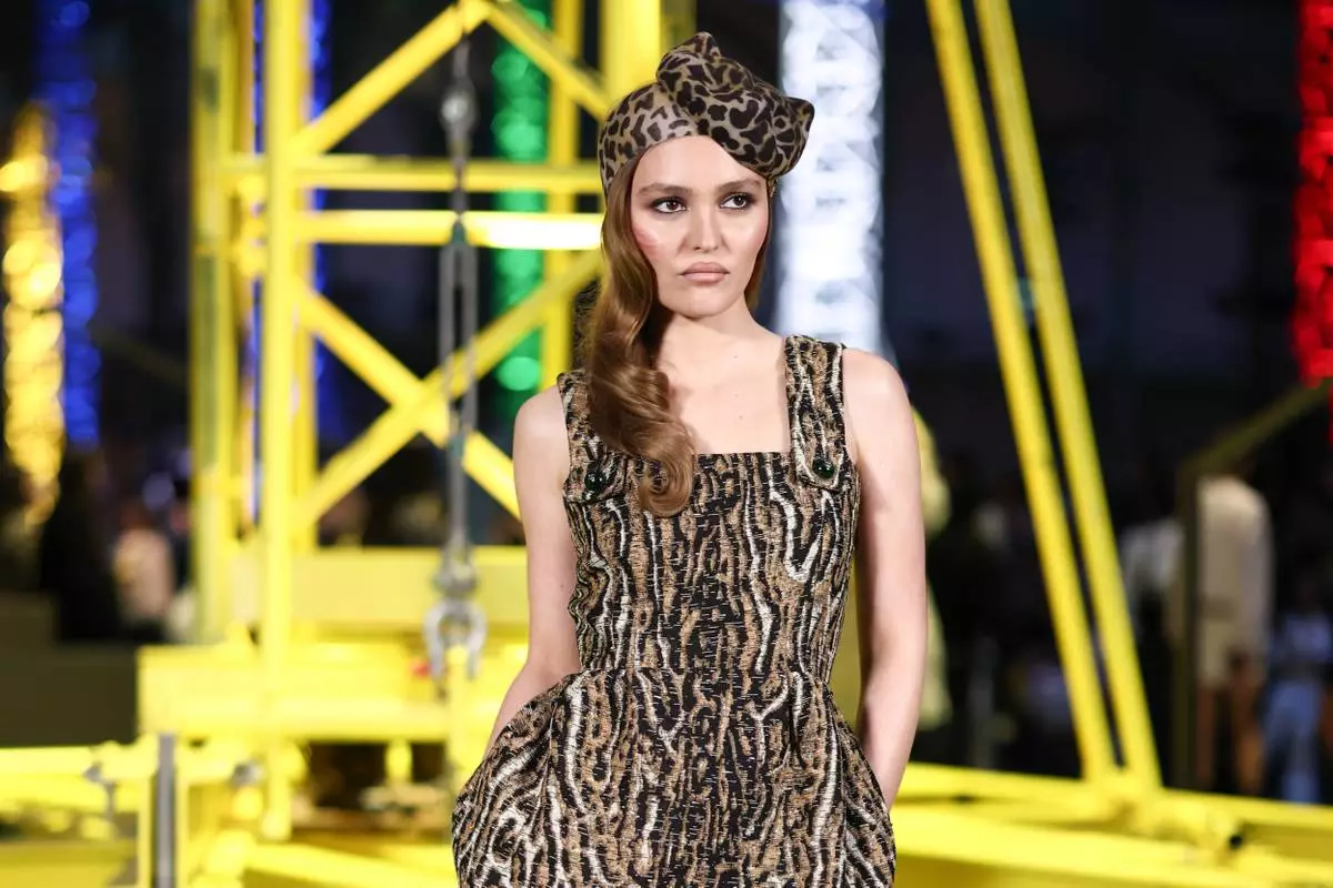 Lily-Rose Depp poses for photographers upon arrival for the Chanel Fall/Winter 2026-2027 Women's collection presented in Paris, Monday, March 9, 2026. (AP Photo/Tom Nicholson)