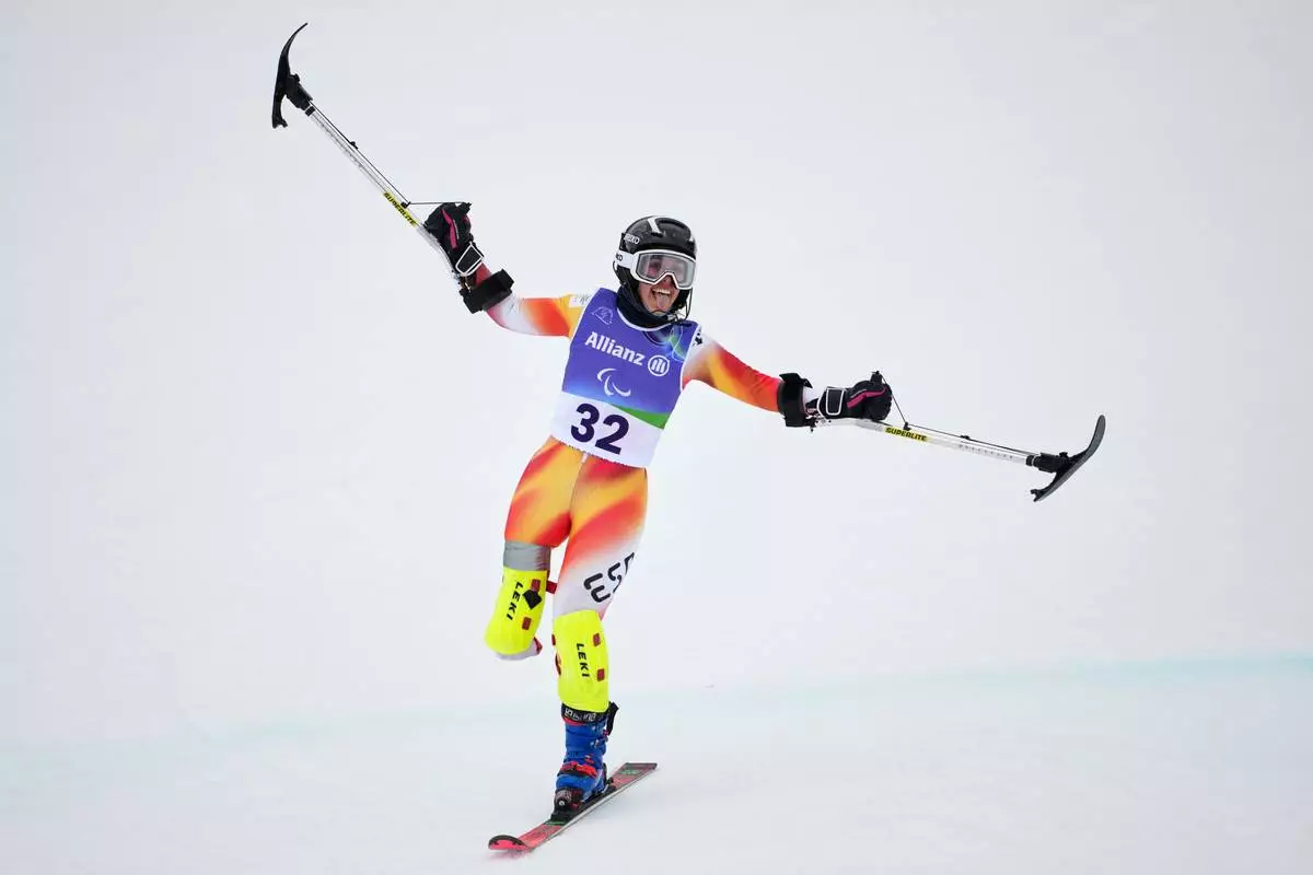Maria Martin-Granizo, of Spain, crosses the finish line on her second run of the alpine skiing women's giant slalom standing at the 2026 Winter Paralympics, in Cortina d'Ampezzo, Italy, Saturday, March 14, 2026. (AP Photo/Evgeniy Maloletka)