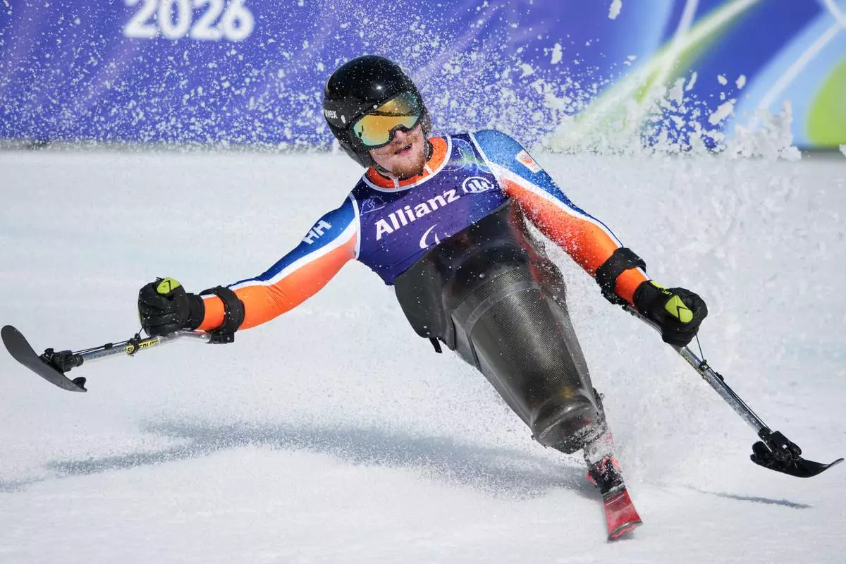 Pascal Christen, of Switzerland, reacts after competing in the alpine skiing men's downhill sitting competition at the 2026 Winter Paralympics, in Cortina d'Ampezzo, Italy, Saturday, March 7, 2026. (AP Photo/Emilio Morenatti)