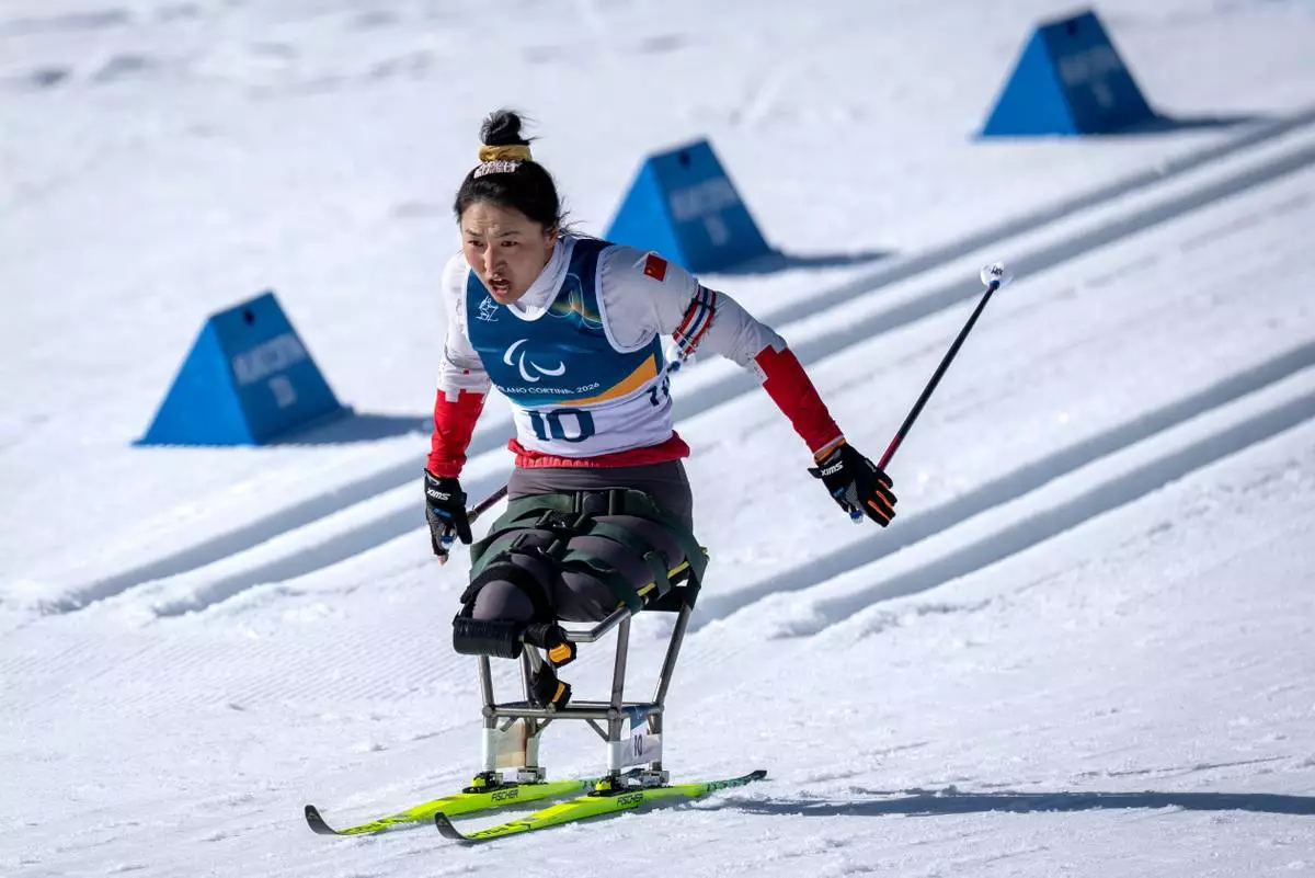 China's Shiyu Wang competes in the Para Biathlon Women's sprint sitting at the 2026 Winter Paralympics, in Tesero, Italy, Saturday, March 7, 2026. (AP Photo/Kirsty Wigglesworth)