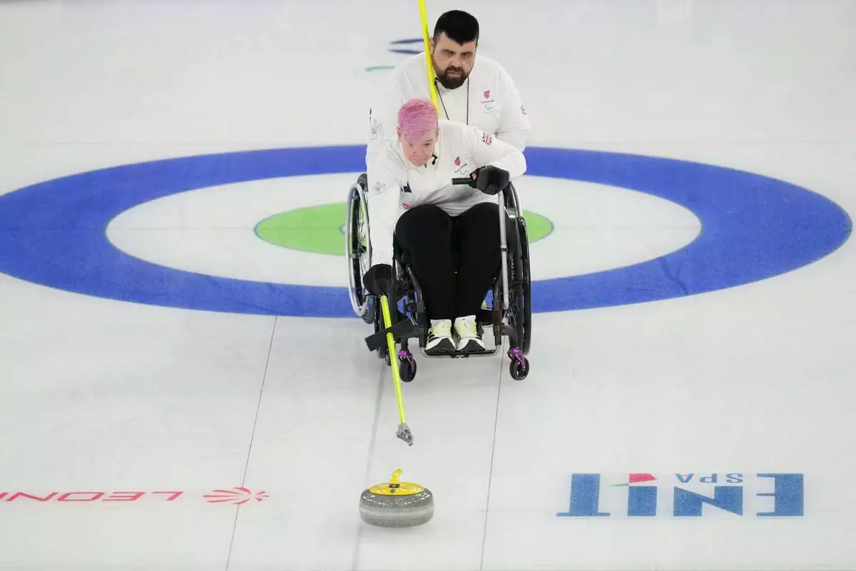 Joanna Butterfield and Jason Kean competes against Latvia during a wheelchair curling mixed doubles at the 2026 Winter Paralympics, in Cortina d'Ampezzo, Italy, Thursday, March 5, 2026. (AP Photo/Evgeniy Maloletka)