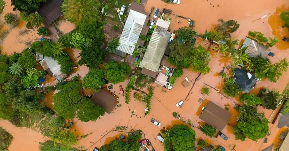 Hawaii digs out from another round of flooding after a surprise downpour, in photos