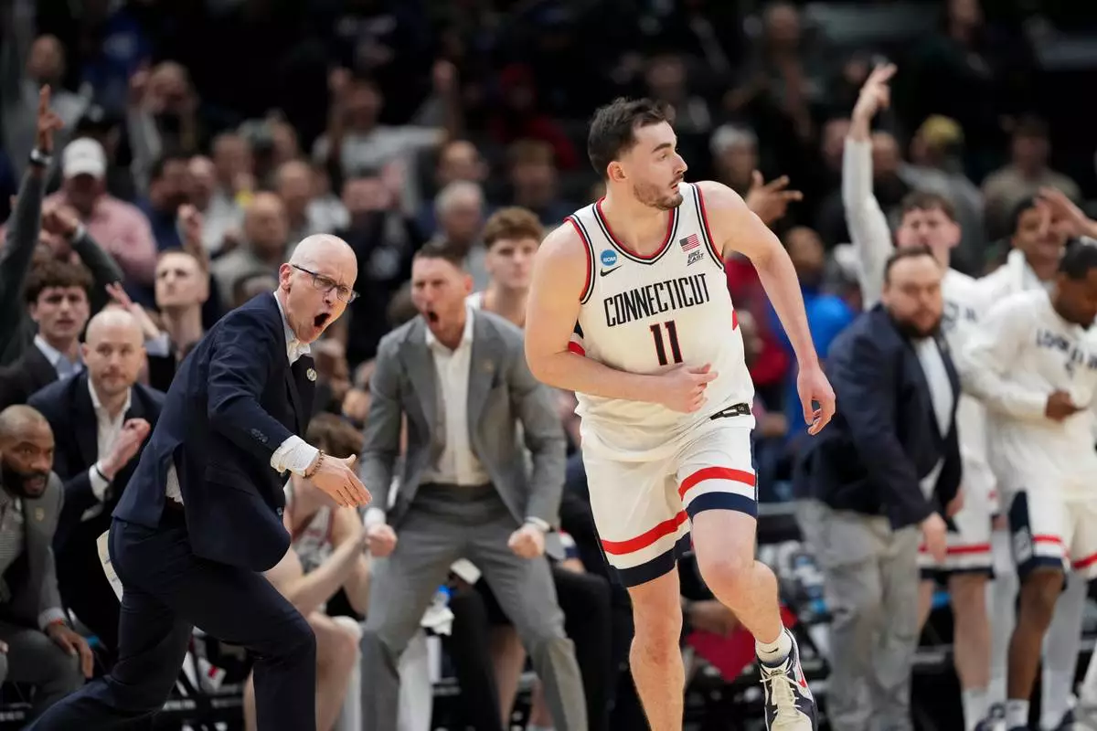 UConn forward Alex Karaban (11) celebrates a three pointer against Michigan State during the second half in the Sweet 16 of the NCAA college basketball tournament, Friday, March 27, 2026, in Washington. (AP Photo/Stephanie Scarbrough)
