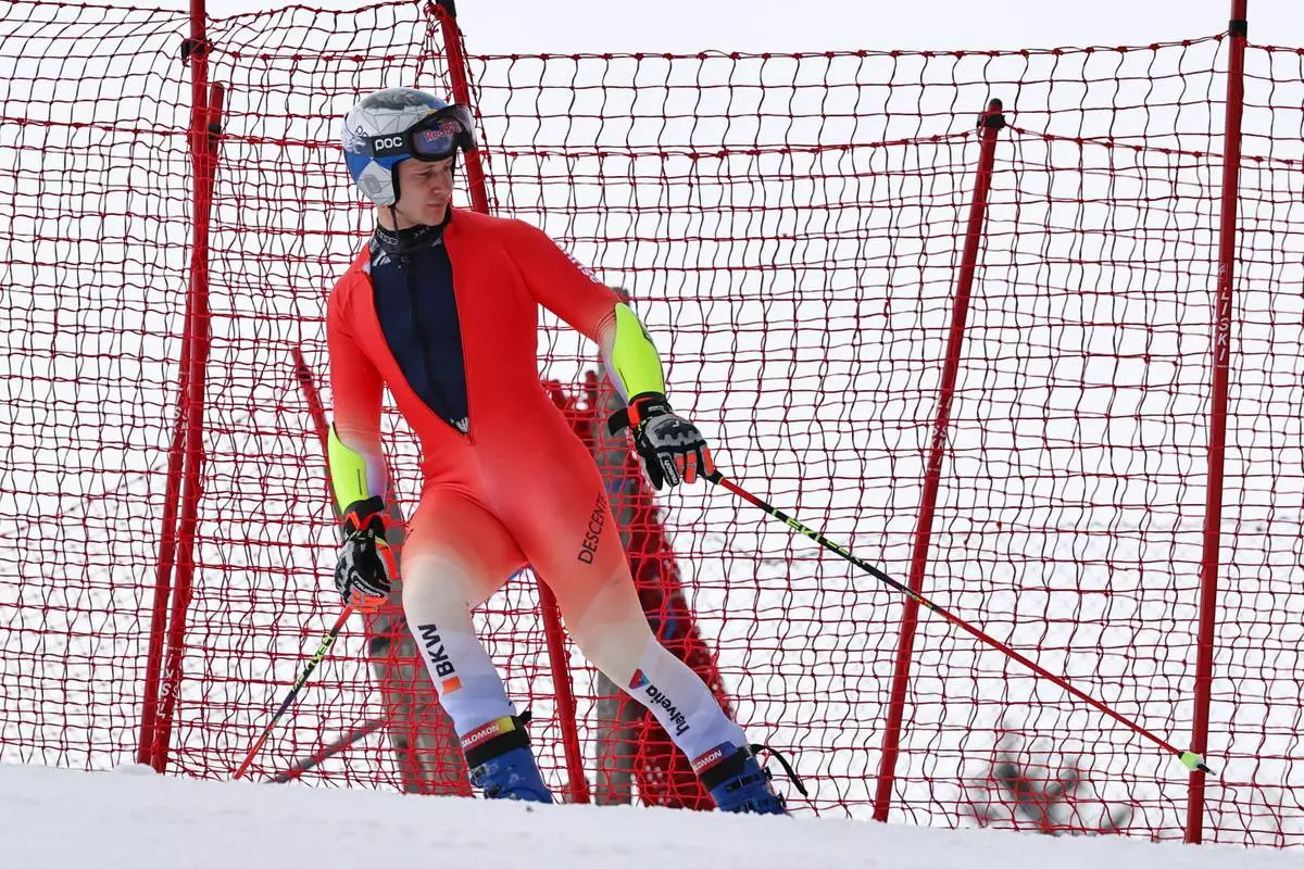 Switzerland's Marco Odermatt stands after skiing off course during an alpine ski, men's giant slalom race, at the Lillehammer World Cup Finals, in Hafjell, Norway, Tuesday, March 24, 2026. (AP Photo/Marco Trovati)