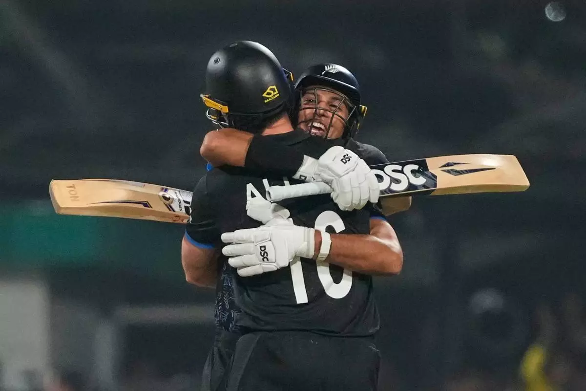 New Zealand's Rachin Ravindra with his batting partner Finn Allen celebrate after wining against South Africa during the first T20 World Cup cricket semifinal match in Kolkata, India, Wednesday, March 4, 2026. (AP Photo/Anupam Nath)