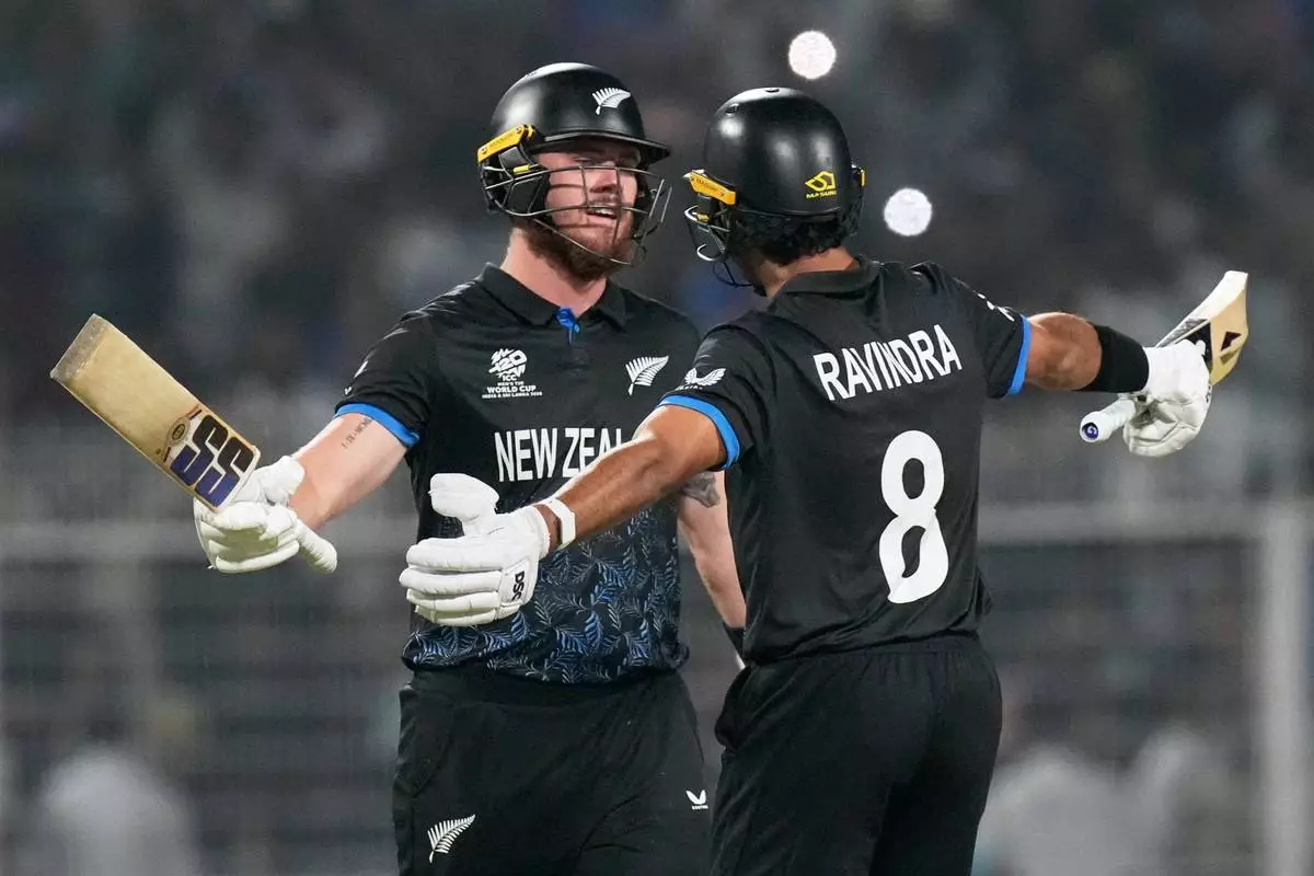 New Zealand's Finn Allen, left, celebrates with batting partner Rachin Ravindra after New Zealand won the first T20 World Cup cricket semifinal match against South Africa in Kolkata, India, Wednesday, March 4, 2026. (AP Photo/Bikas Das)