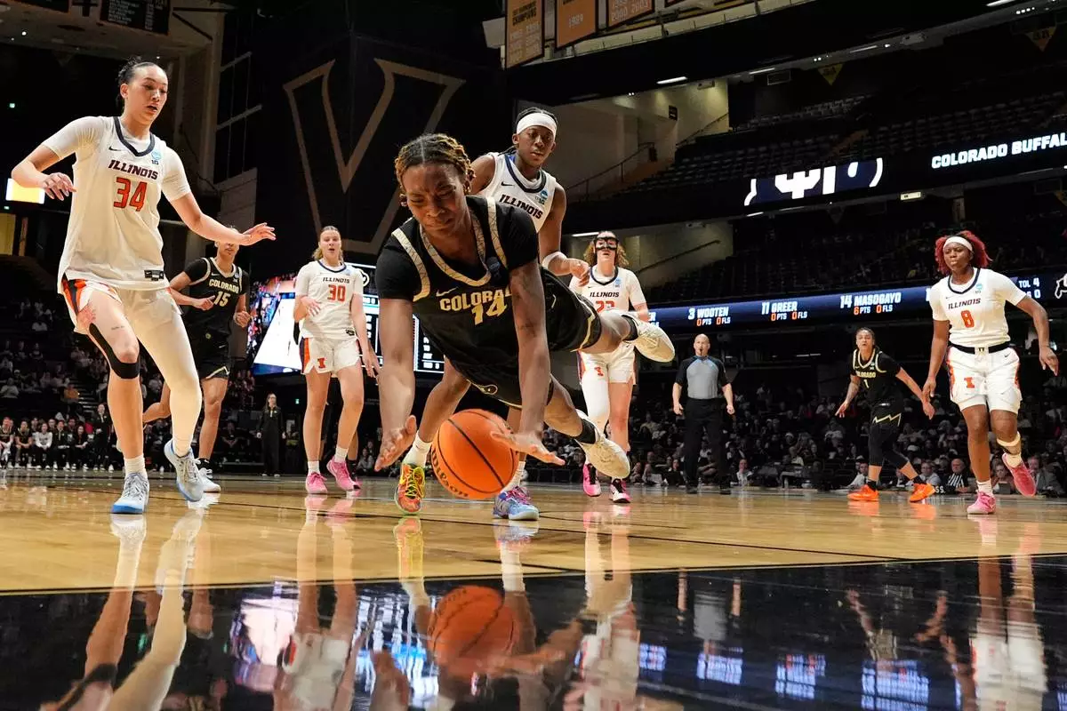 Colorado forward Jade Masogayo (14) dives for a loose ball during the first half in the first round of the NCAA college basketball tournament against Illinois, Saturday, March 21, 2026, in Nashville, Tenn. (AP Photo/George Walker IV)