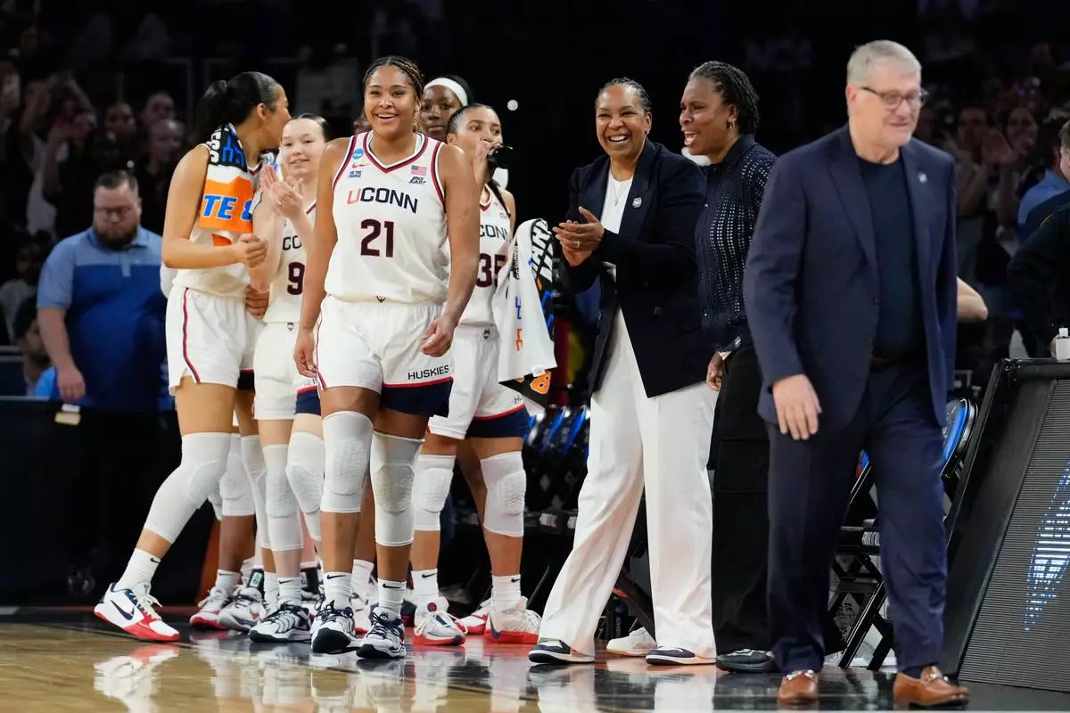 UConn forward Sarah Strong and teammates react at the end of a game against the Notre Dame in the Elite Eight of the NCAA college basketball tournament, Sunday, March 29, 2026, in Fort Worth, Texas. (AP Photo/Tony Gutierrez)