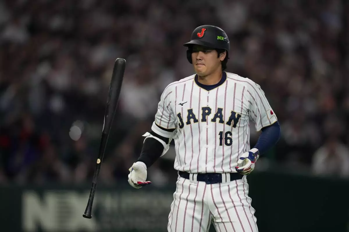 Japan's Shohei Ohtani reacts after a foul ball during the first inning of a World Baseball Classic game between Japan and South Korea on Saturday, March 7, 2026 in Tokyo, Japan. (AP Photo/Hiro Komae)