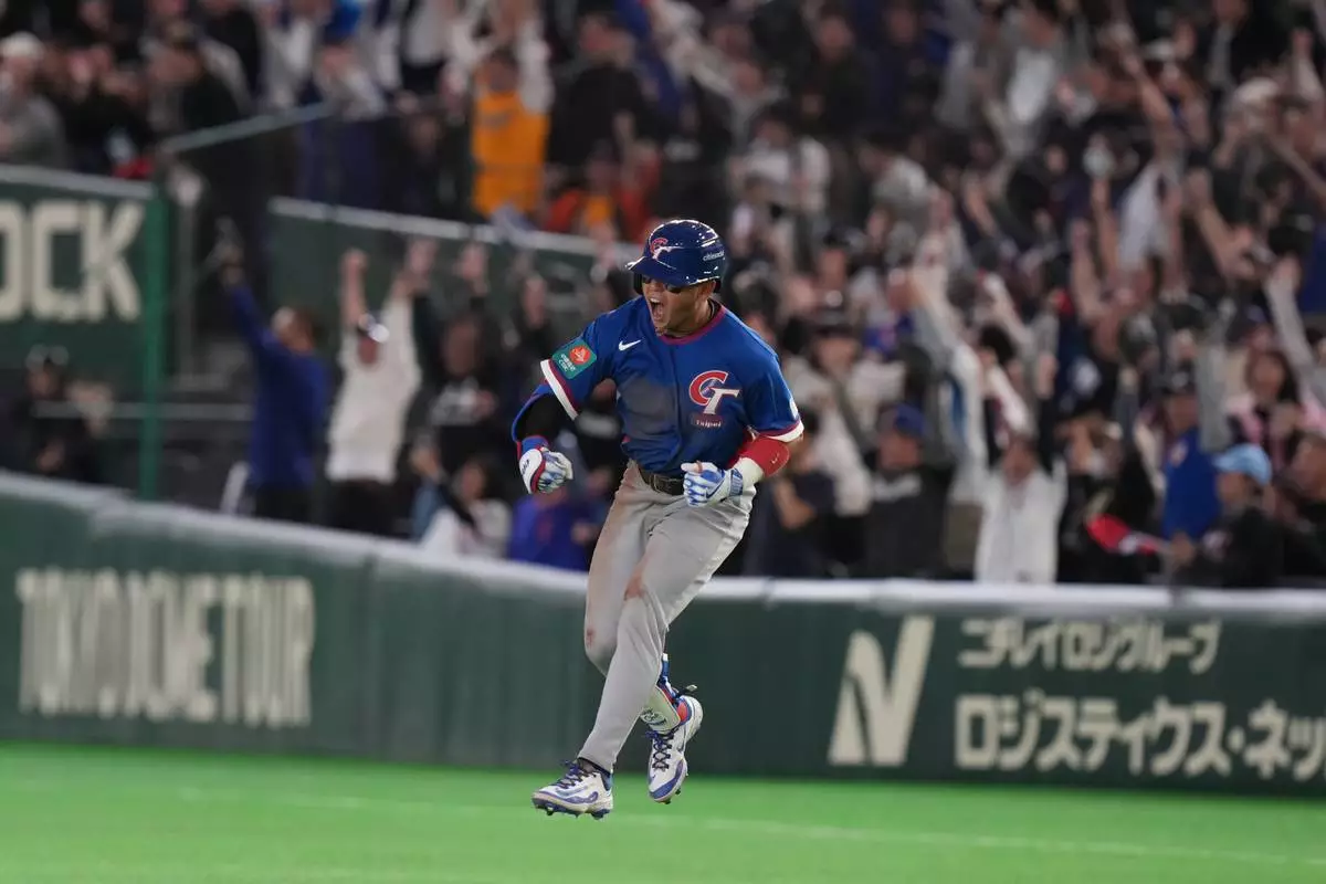 Taiwan's Cheng Tsung-che celebrates his home run during the sixth inning of a World Baseball Classic game between South Korea and Taiwan on Sunday, March 8, 2026 in Tokyo, Japan. (AP Photo/Eugene Hoshiko)