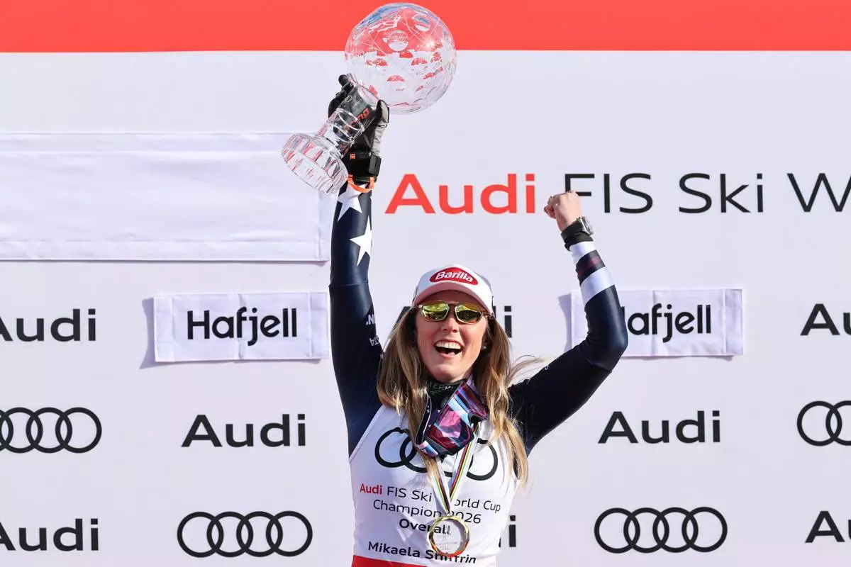 United States' Mikaela Shiffrin celebrates winning the women's overall World Cup skiing title, at the Lillehammer World Cup Finals, in Hafjell, Norway, Wednesday, March 25, 2026. (AP Photo/Marco Trovati)