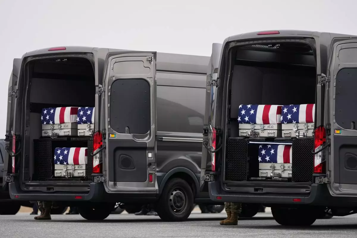 Transfer vans containing the remains of U.S. Army Reserve soldiers Maj. Jeffrey O'Brien, 45, of Indianola, Iowa, Capt. Cody Khork, 35, of Winter Haven, Florida, Chief Warrant Officer 3 Robert Marzan, 54, of Sacramento, Sgt. 1st Class Nicole Amor, 39, of White Bear Lake, Minnesot, Sgt. 1st Class Noah Tietjens, 42, of Bellevue, Nebraska and Sgt. Declan Coady, 20, of West Des Moines, Iowa, who were killed in a drone strike at a command center in Kuwait one day after the U.S. and Israel launched its military campaign against Iran, during a casualty return, Saturday, March 7, 2025, at Dover Air Force Base, Del. (AP Photo/Julia Demaree Nikhinson)
