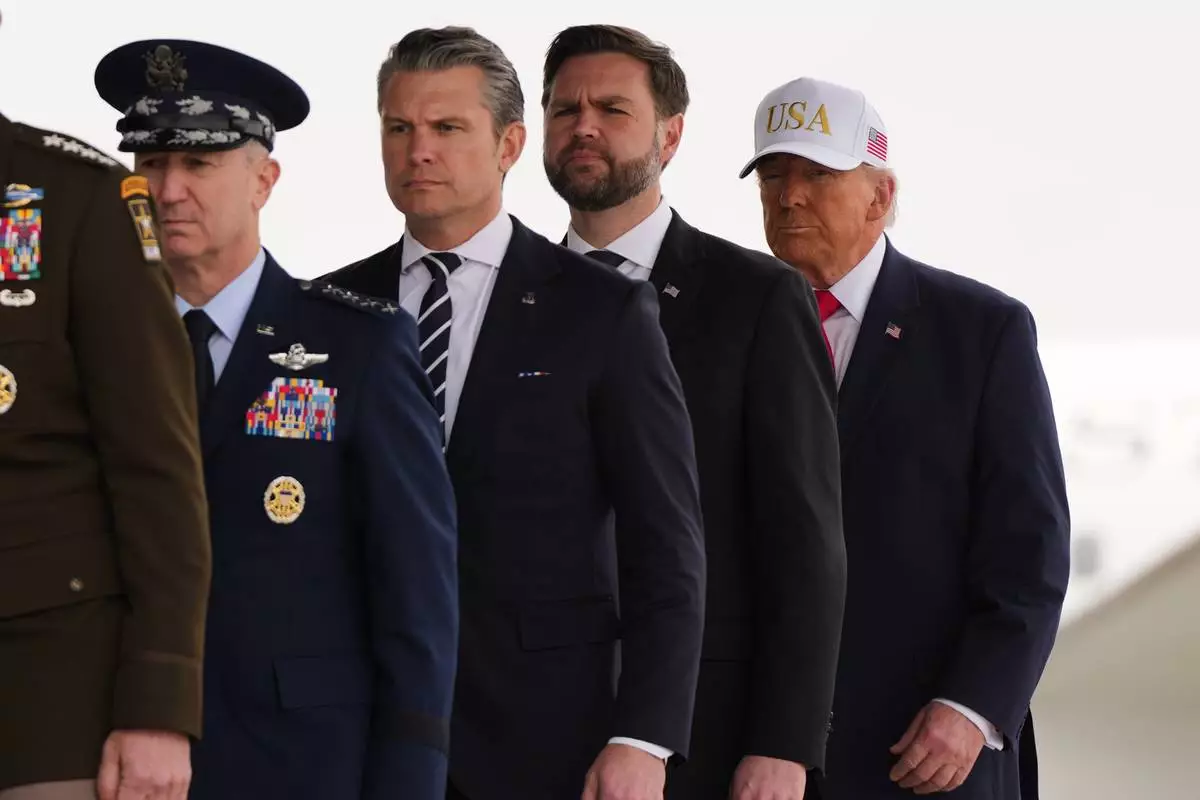 President Donald Trump, from right, Vice President JD Vance, Defense Secretary Pete Hegseth, Chairman of the Joint Chiefs of Staff Gen. Dan Caine, walk after a prayer during a casualty return for the six U.S. Army Reserve soldiers who were killed in a drone strike at a command center in Kuwait after the U.S. and Israel launched its military campaign against Iran, during a casualty return Saturday, March 7, 2026, at Dover Air Force Base, Del. (AP Photo/Julia Demaree Nikhinson)