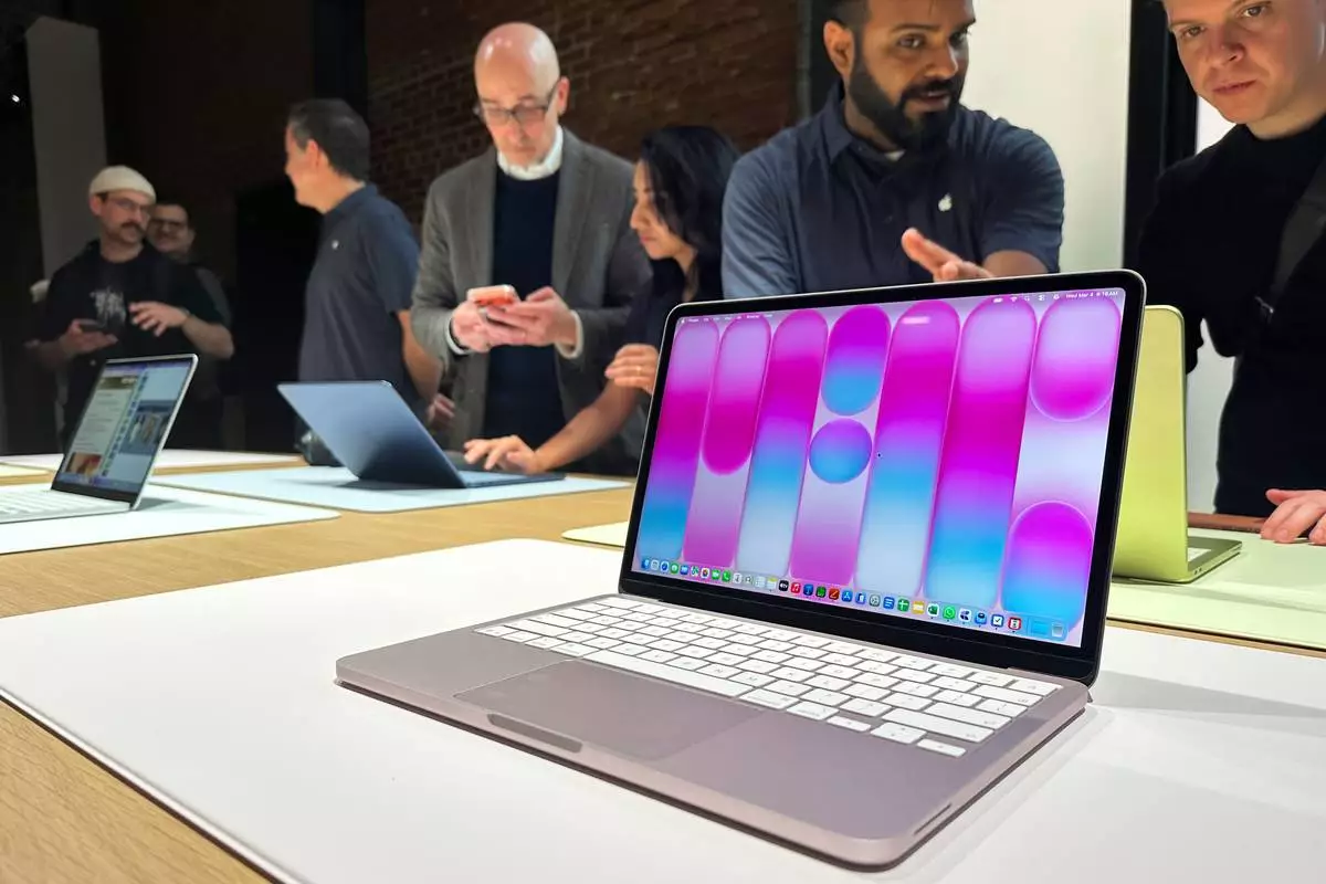A MacBook Neo sits on display during an Apple unveil event, Wednesday, March 4, 2026, in New York (AP Photo/Ted Shaffrey) ,