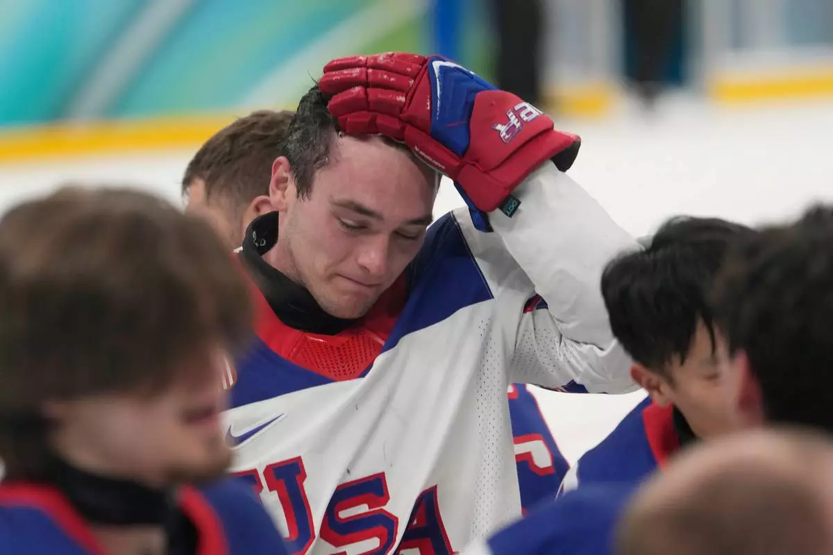 United States's Jack Wallace celebrates after winning the gold medal at the end of the ice hockey match between United States and Canada at the 2026 Winter Paralympics, in Milan, Italy, Sunday, March 15, 2026. (AP Photo/Luca Bruno)