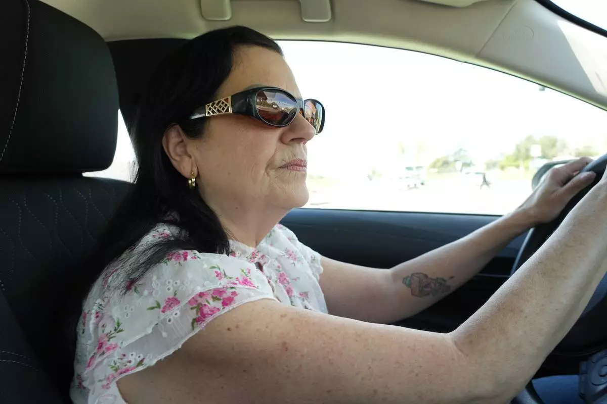 Leslie Sherman-Shafer, an Uber driver, drives her car in Alameda, Calif, March 23, 2026. (AP Photo/Terry Chea)