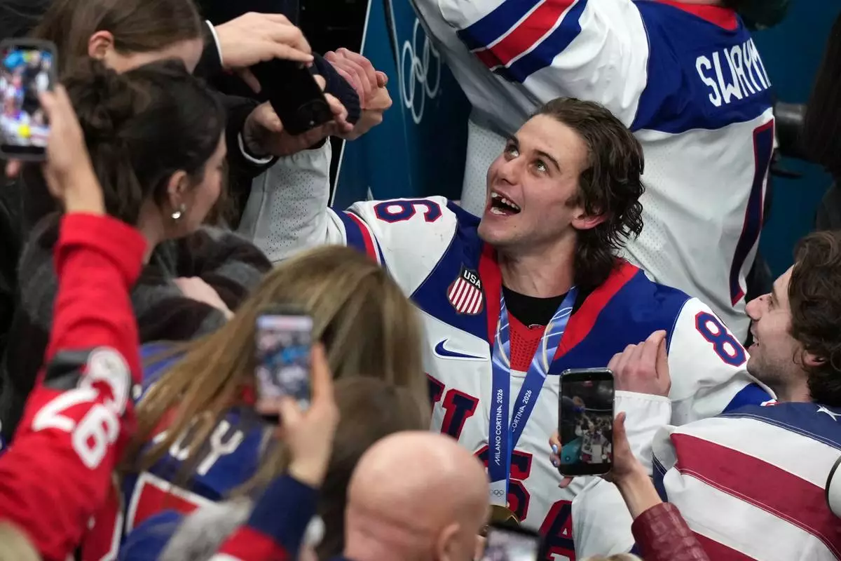 United States' Jack Hughes (86), who scored the winning overtime goal, celebrates after defeating Canada in the men's ice hockey gold medal game at the 2026 Winter Olympics in Milan, Italy, Sunday, Feb. 22, 2026. (AP Photo/Carolyn Kaster)