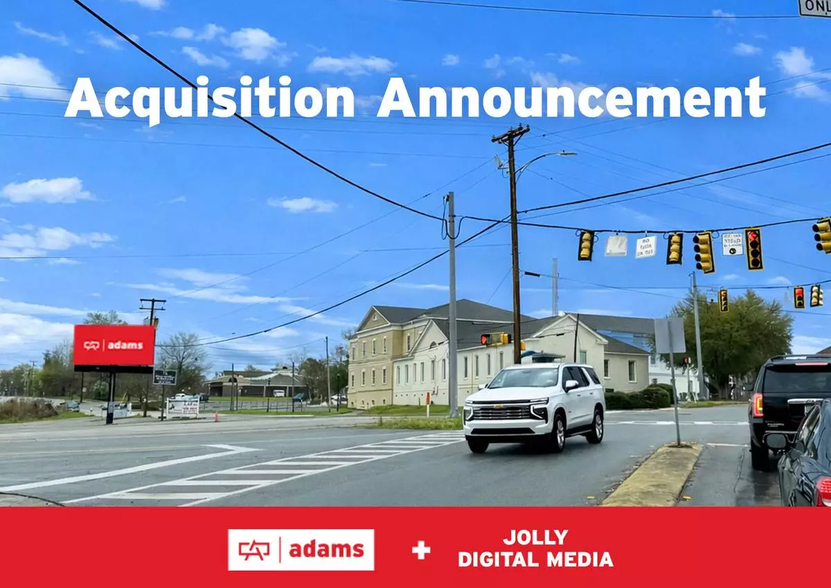A newly acquired digital billboard from Jolly Digital Media stands at a signalized intersection in downtown Barnwell, South Carolina, now part of Adams Outdoor Advertising’s expanding network. Positioned along a key travel route, the display faces oncoming traffic and provides strong visibility to drivers navigating the intersection. Surrounded by local buildings, utility lines, and everyday traffic flow, the billboard reflects its role as both an advertising platform and a community communication tool. The digital screen, currently displaying an Adams message, highlights the unit’s capability for timely, rotating content. This location offers businesses and organizations an opportunity to reach residents and pass-through traffic with flexible, high-impact messaging in the center of the community.