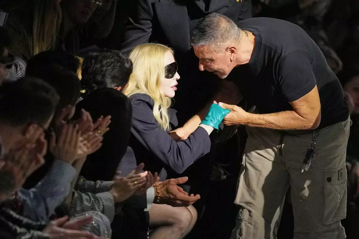 Madonna congratulates Stefano Gabbana at the end of the Dolce &amp; Gabbana Fall/Winter 2026-2027 Women's collection, presented in Milan, Italy, Saturday, Feb. 28, 2026. (AP Photo/Antonio Calanni)