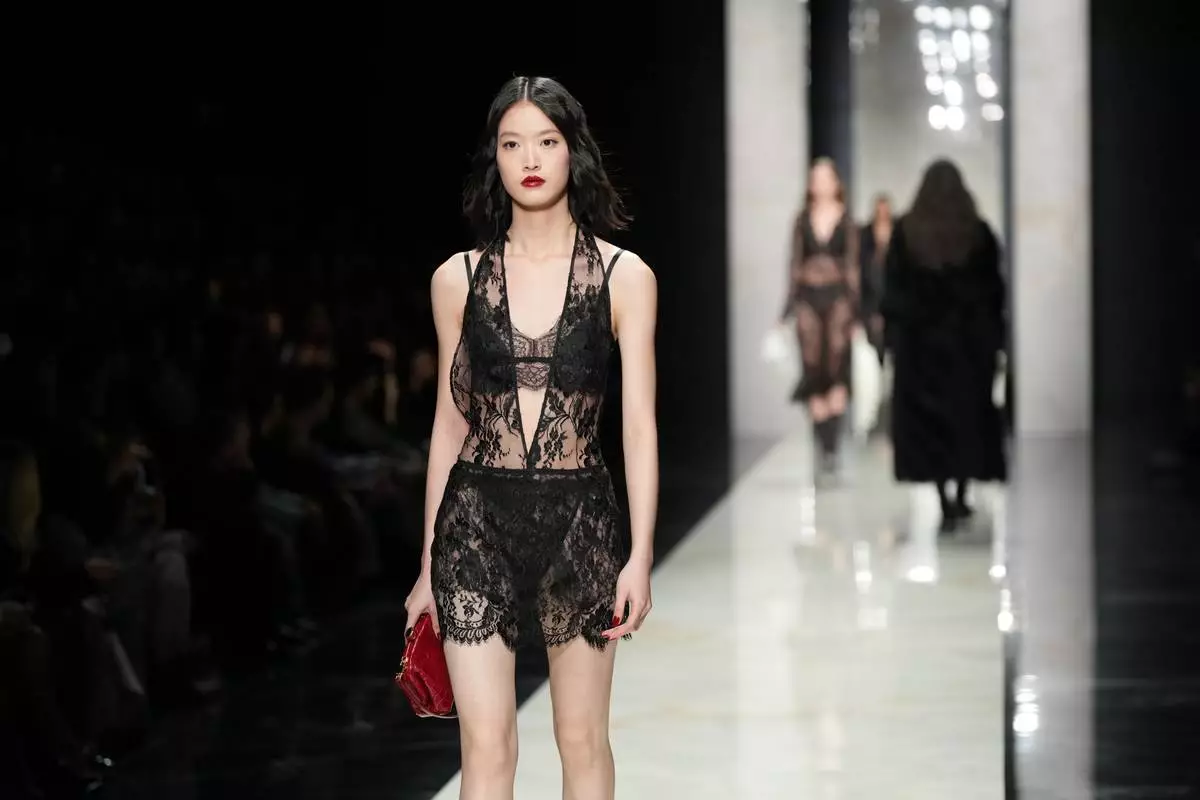 A model wears a creation from the Dolce &amp; Gabbana Fall/Winter 2026-2027 Women's collection, presented in Milan, Italy, Saturday, Feb. 28, 2026. (AP Photo/Antonio Calanni)