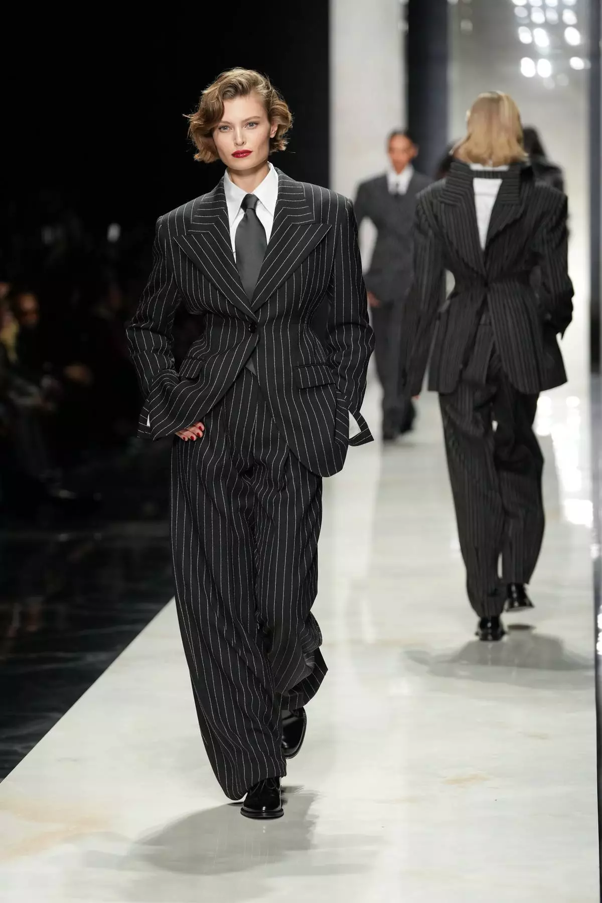 A model wears a creation from the Dolce &amp; Gabbana Fall/Winter 2026-2027 Women's collection, presented in Milan, Italy, Saturday, Feb. 28, 2026. (AP Photo/Antonio Calanni)