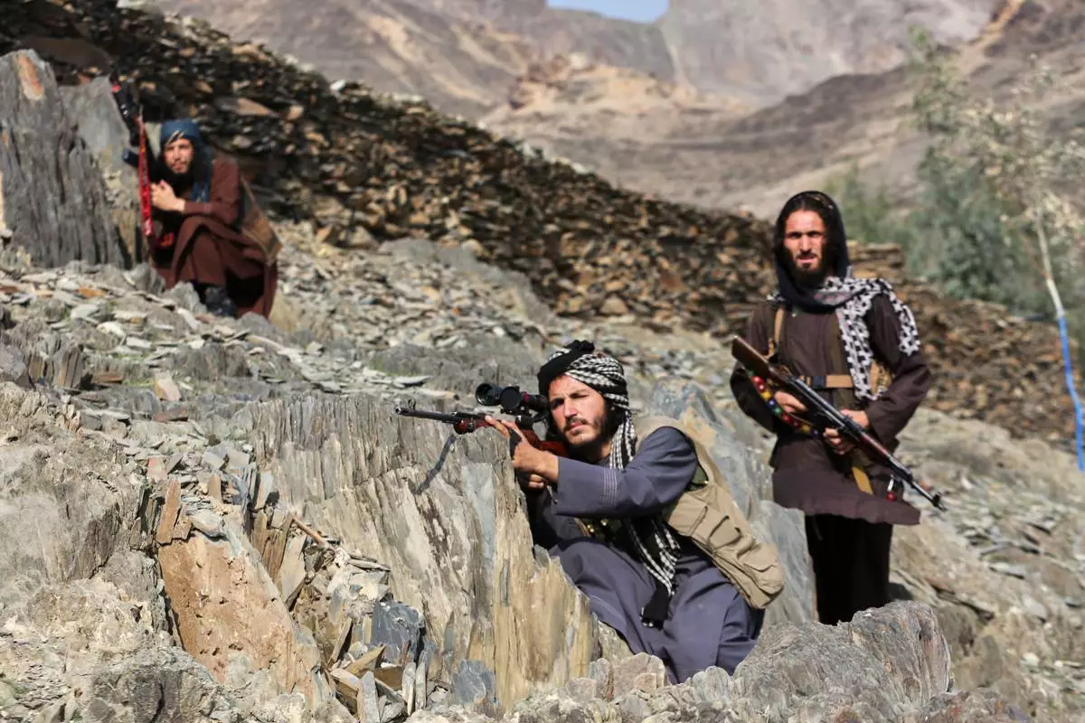 Afghan Taliban soldiers look toward the Pakistani side, on the Afghan side of the Torkham border crossing with Pakistan in Torkham, Afghanistan, Friday, Feb. 27, 2026. (AP Photo/Wahidullah Kakar)