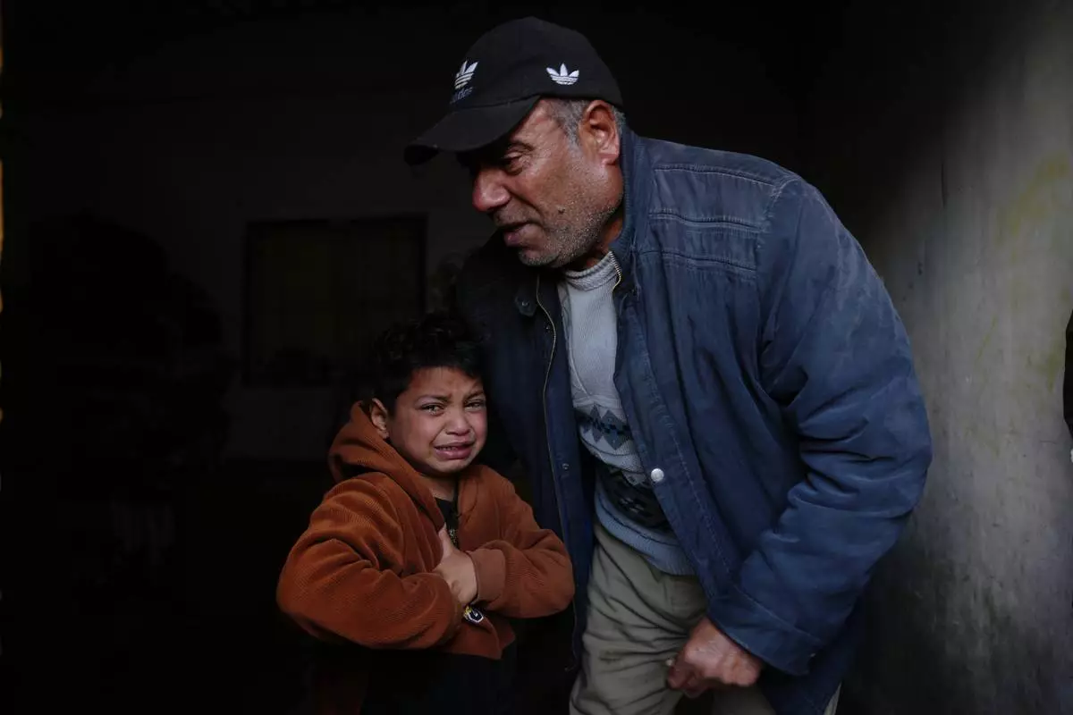 Yazid Al-Zayan, 9, mourns during the funeral for his father, Khaled Al-Zayan, a Palestinian policeman, who was killed in an Israeli military strike, in Khan Younis, southern Gaza Strip, Friday, Feb. 27, 2026. (AP Photo/Abdel Kareem Hana)