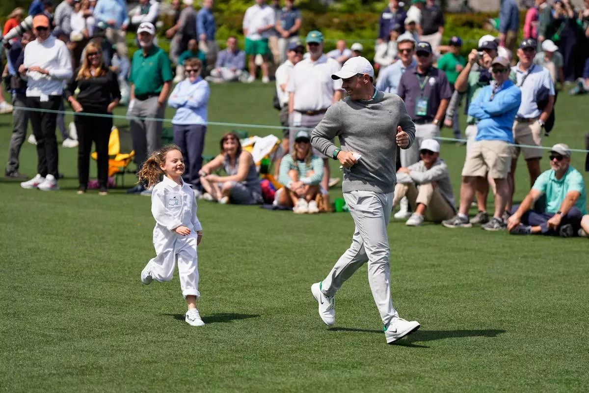 FILE - Rory McIlroy, right, runs with his daughter, Poppy, during par-3 contest ahead of the Masters golf tournament at the Augusta National Golf Club, Wednesday, April 8, 2026, in Augusta, Ga. (AP Photo/Ashley Landis, File)