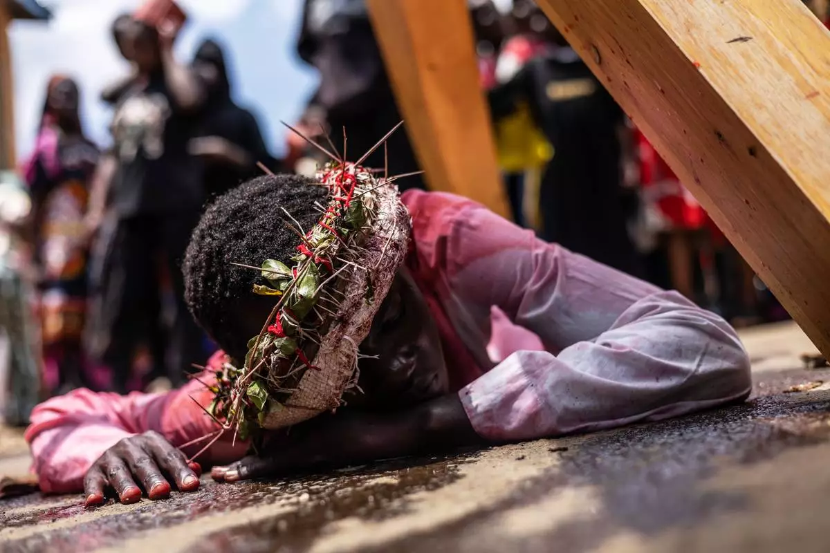 FILE - Christians take part in a Way of the Cross re-enactment of the crucifixion of Jesus Christ on Good Friday during Holy Week in Kibera informal settlement in Nairobi, Kenya, Friday, April 3, 2026. (AP Photo/Samson Otieno, File)