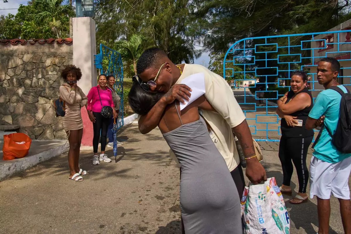 FILE - A pardoned prisoner hugs a family member outside La Lima penitentiary after his release in Guanabacoa, Havana, Cuba, Friday, April 3, 2026. (AP Photo/Ramon Espinosa, File)
