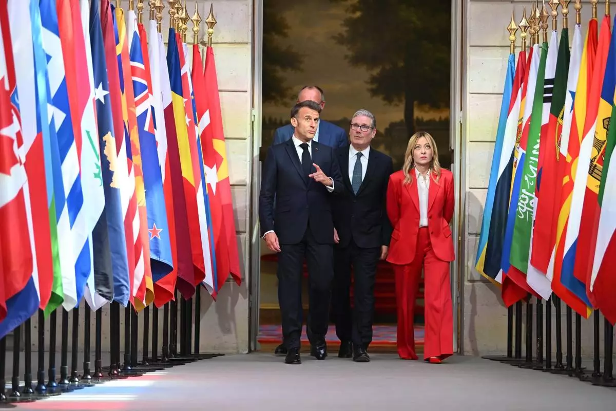 German chancellor Friedrich Merz, behind, French President Emmanuel Macron, left, British Prime Minister Keir Starmer, centre, and Italian Prime Minister Giorgia Meloni arrive at the Elysee Palace for a conference on the initiative for maritime navigation in the Strait of Hormuz, in Paris, Friday April 17, 2026 (Jeanne Accorsini/Pool Photo via AP)