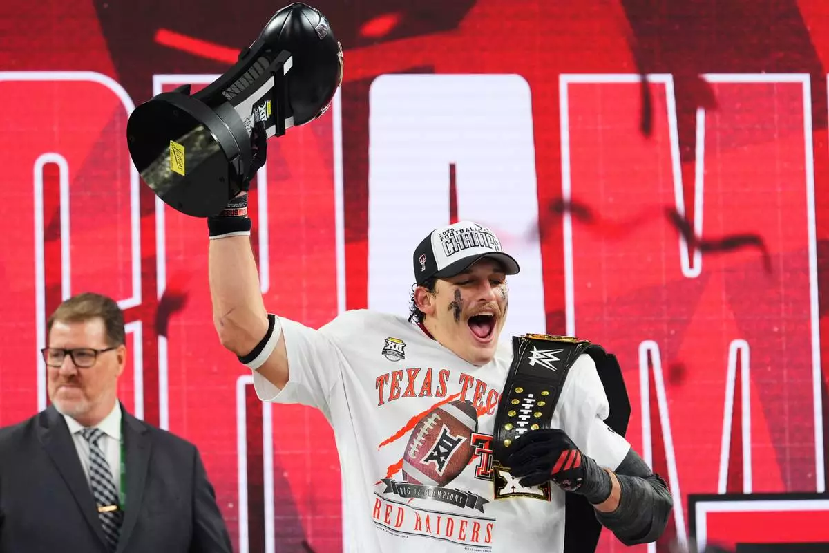 FILE - Texas Tech linebacker Ben Roberts celebrates after being awared the Most Outstanding Player trophy following the team's win in the Big 12 Conference championship NCAA college football game against BYU, Dec. 6, 2025, in Arlington, Texas. (AP Photo/Julio Cortez, File)