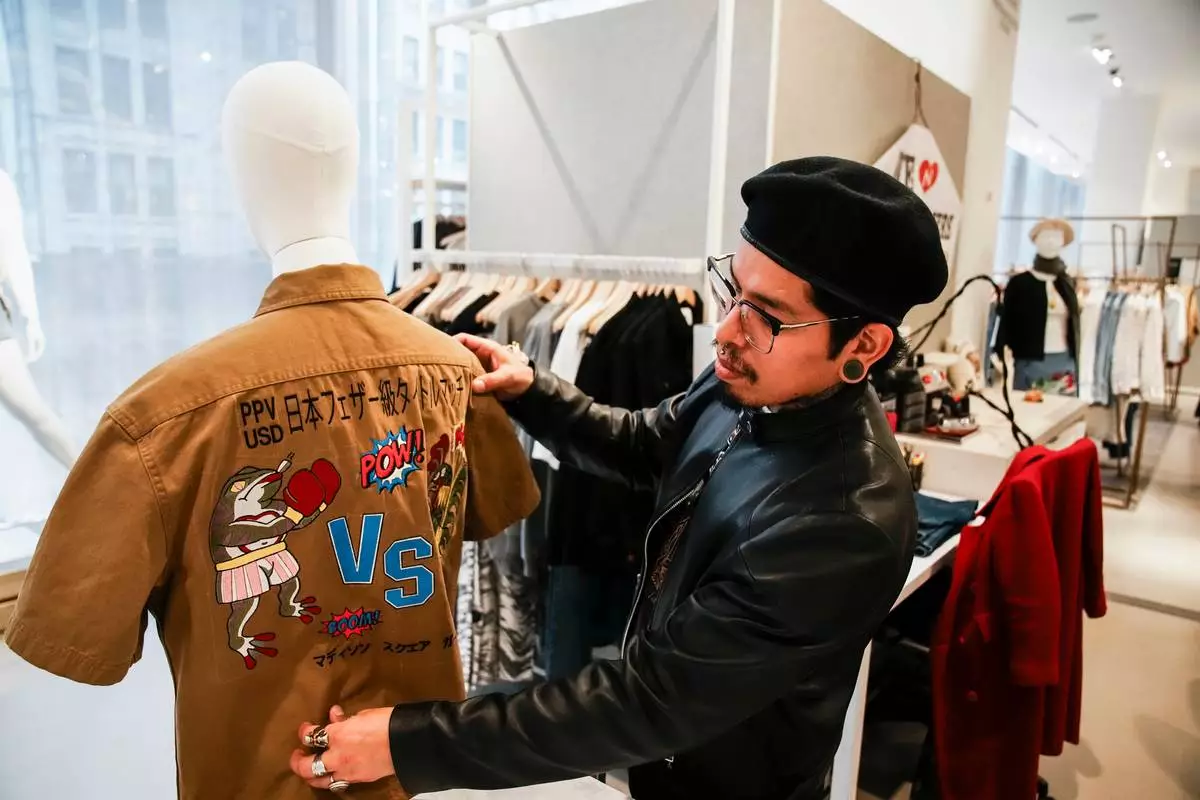 Tailor Marco Lema, 35, of Ecuador, works on an embroidered shirt at Nordstrom Manhattan flagship in New York, Monday, March 23, 2026. (AP Photo/Eduardo Munoz Alvarez) CORRECTION: Corrects to Nordstrom Manhattan flagship, not Nordstrom headquarters