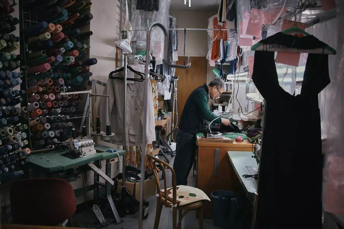 Tailor, Kil Bae, works inside his shop on Friday, March 27, 2026, in New York. (AP Photo/Andres Kudacki)