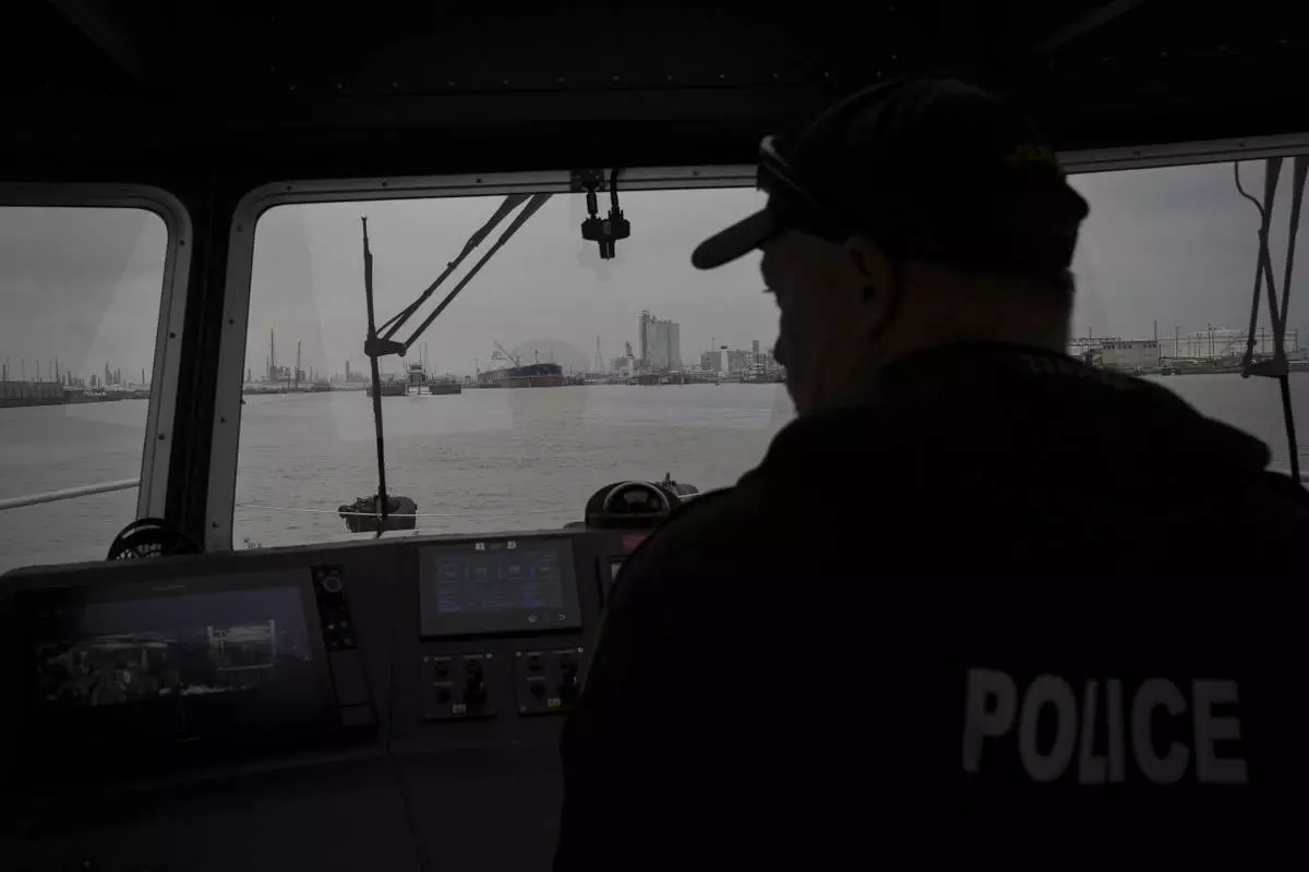 A Port of Corpus Christi police officer guides a boat through the port Thursday, Nov. 16, 2023, in Corpus Christi, Texas. (Jon Shapley/Houston Chronicle via AP)