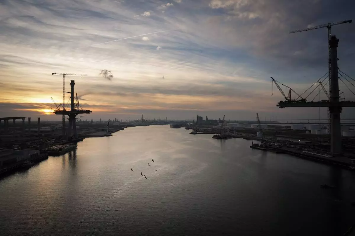 Birds fly over the Port of Corpus Christi as the sun sets Thursday, Nov. 16, 2023, in Corpus Christi, Texas. (Jon Shapley/Houston Chronicle via AP)