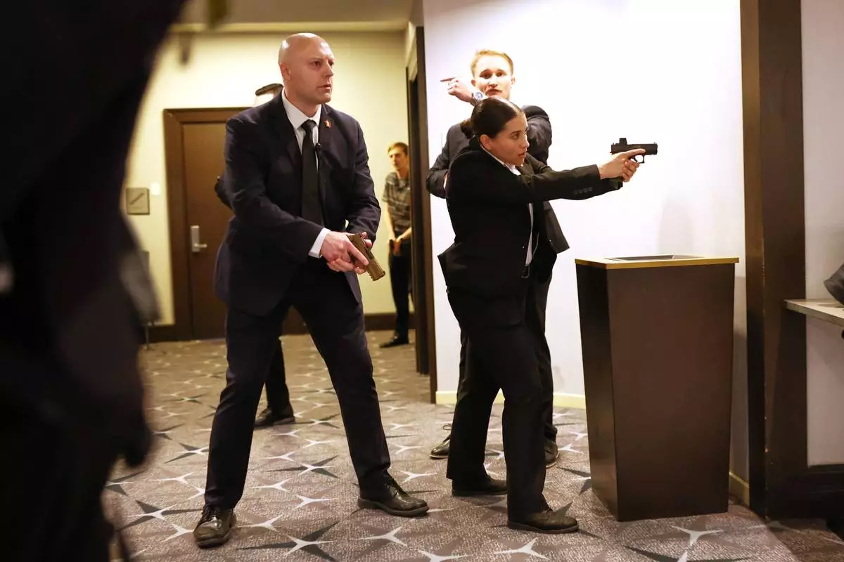 Members of law enforcement respond during the White House Correspondents Dinner, Saturday, April 25, 2026, in Washington. (AP Photo/Tom Brenner)
