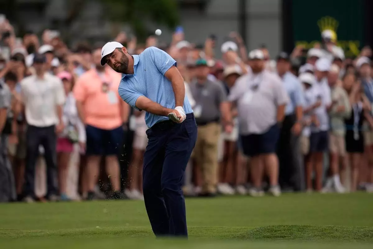Scottie Scheffler chips onto the 18th green during a playoff in the final round of the RBC Heritage golf tournament Sunday, April 19, 2026, in Hilton Head, S.C. (AP Photo/Mike Stewart)