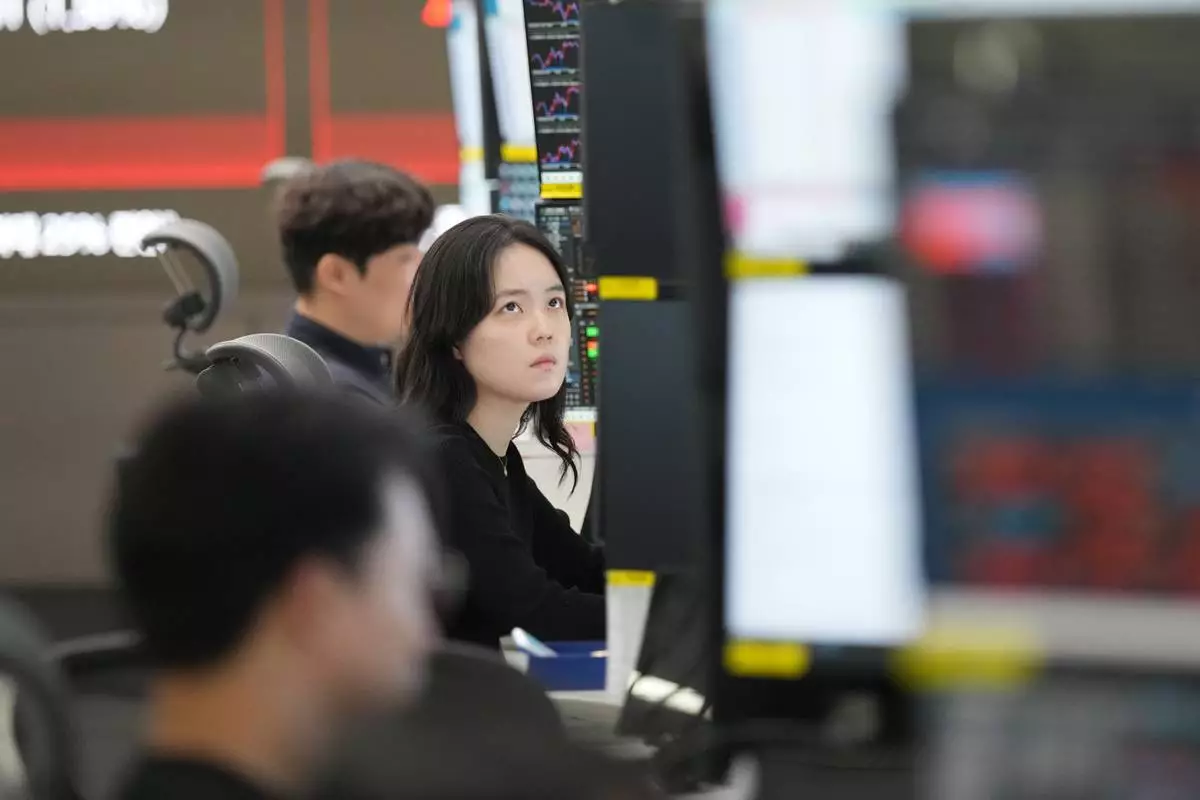 A dealer watches computer monitors at a dealing room of Hana Bank in Seoul, South Korea, Tuesday, April 21, 2026. (AP Photo/Lee Jin-man)