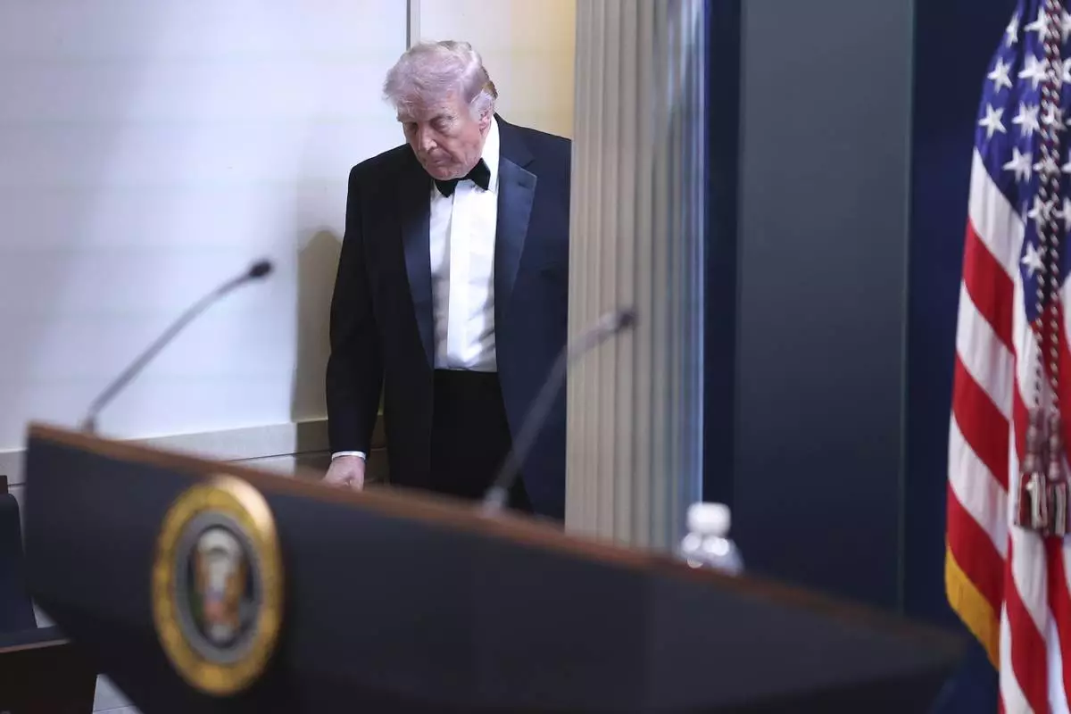 President Donald Trump arrives at the James Brady Press Briefing Room at the White House after an unspecified threat at the annual White House Correspondents' Association Dinner in Washington, Saturday, April 25, 2026. (AP Photo/Tom Brenner)
