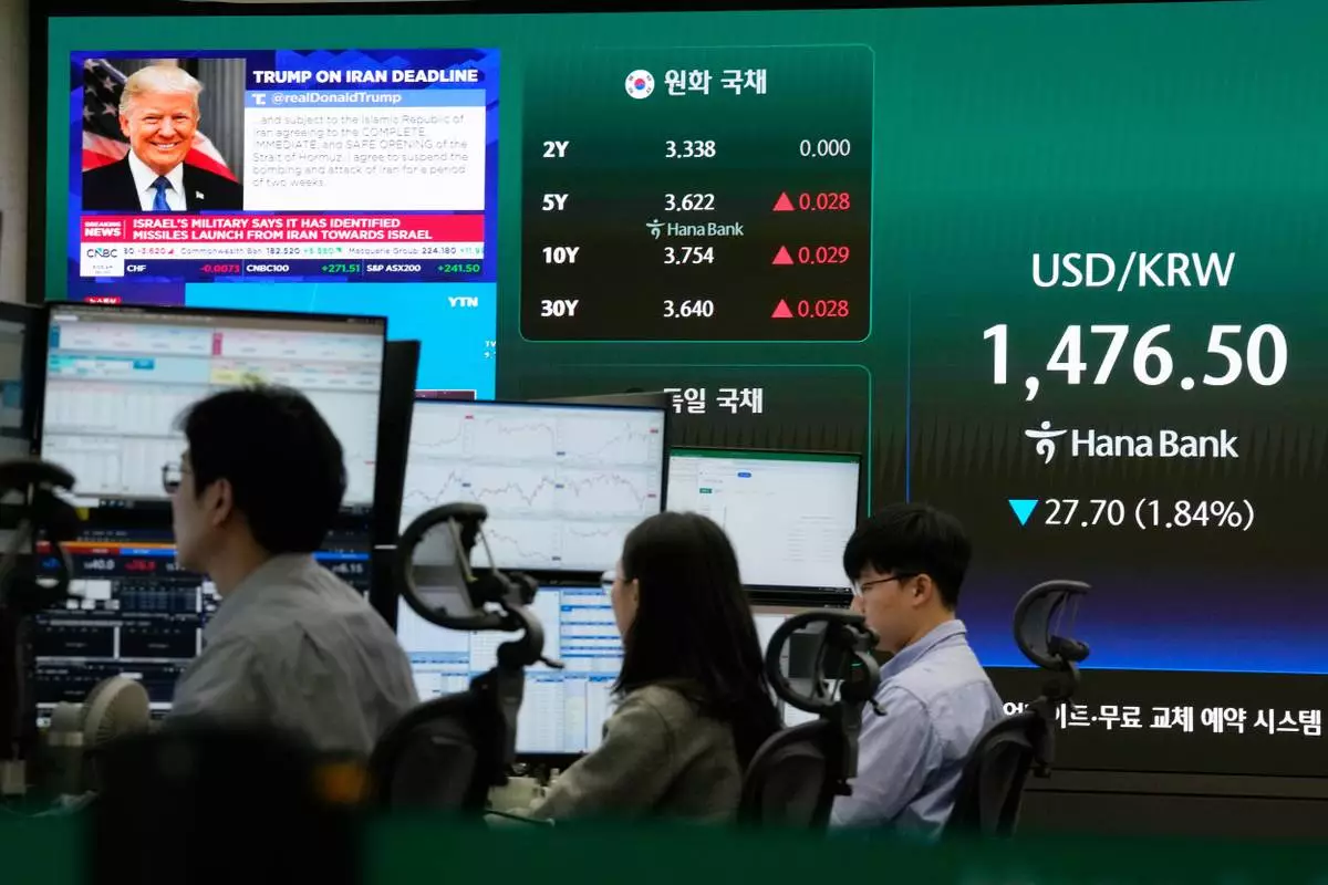 U.S. President Donald Trump is seen on a screen as traders work at the foreign exchange dealing room of the Hana Bank headquarters in Seoul, South Korea, Wednesday, April 8, 2026. (AP Photo/Ahn Young-joon)