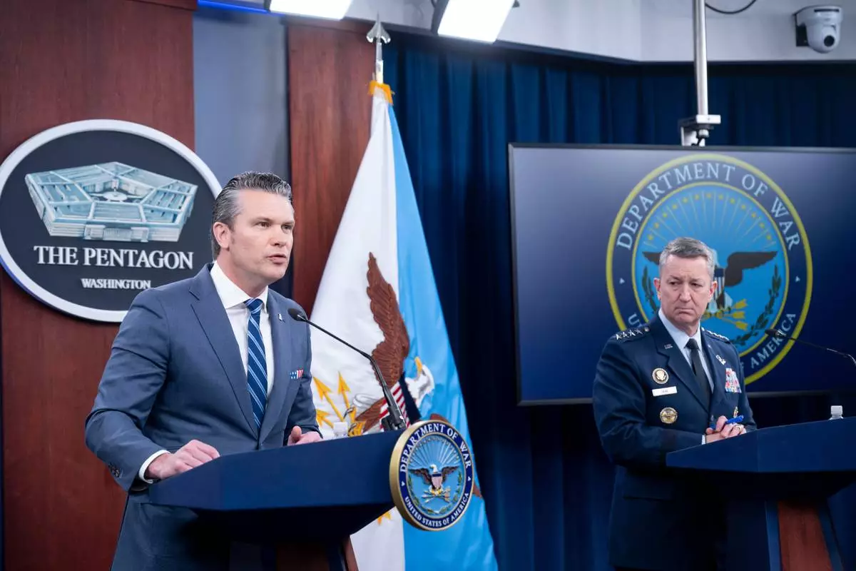 Defense Secretary Pete Hegseth and Chairman of the Joint Chiefs of Staff Gen. Dan Caine speaks to members of the media during a press briefing at the Pentagon, Thursday, April 16, 2026 in Washington. (AP Photo/Kevin Wolf)