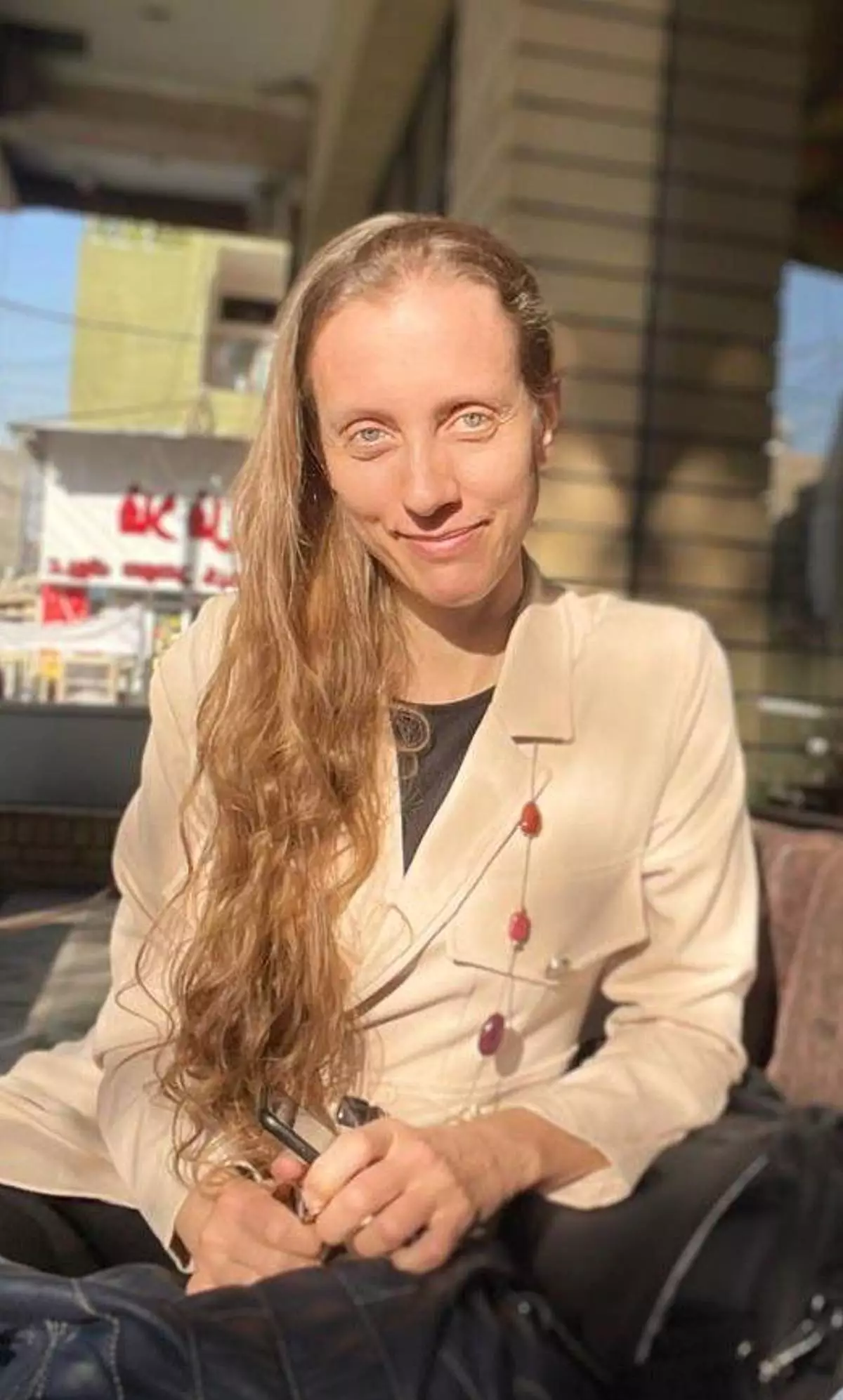 U.S. journalist Shelly Kittleson poses for a cellphone photo in a cafe in Baghdad, Iraq, March 25, 2025. (AP Photo)