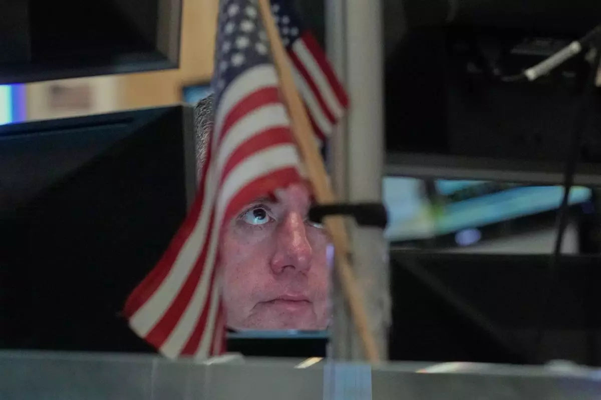 Trader Justin Flinn works on the floor of the New York Stock Exchange, Thursday, April 23, 2026. (AP Photo/Richard Drew)