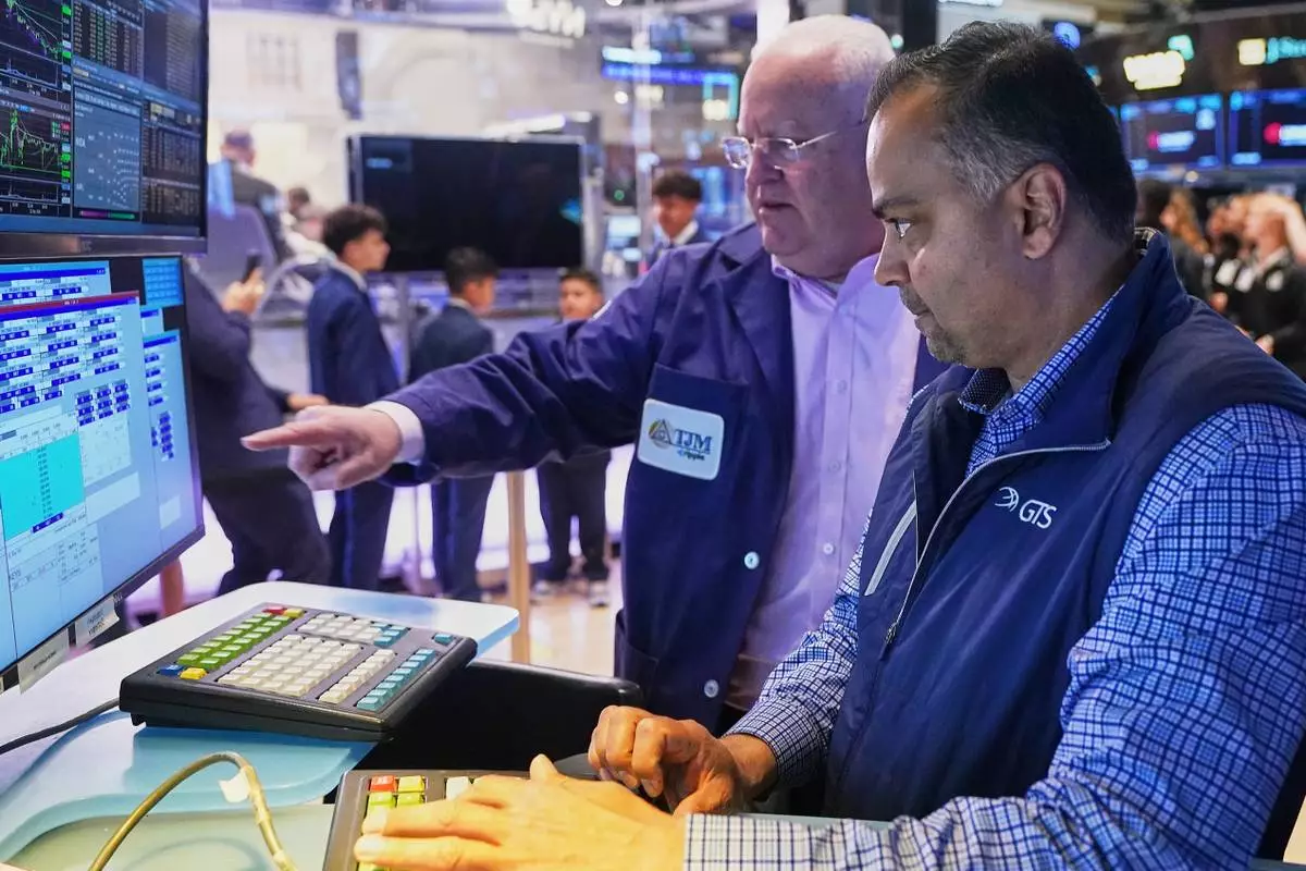 Trader Thomas Ferrigno, left, and specialist Dilip Patel work on the floor of the New York Stock Exchange, Thursday, April 23, 2026. (AP Photo/Richard Drew)