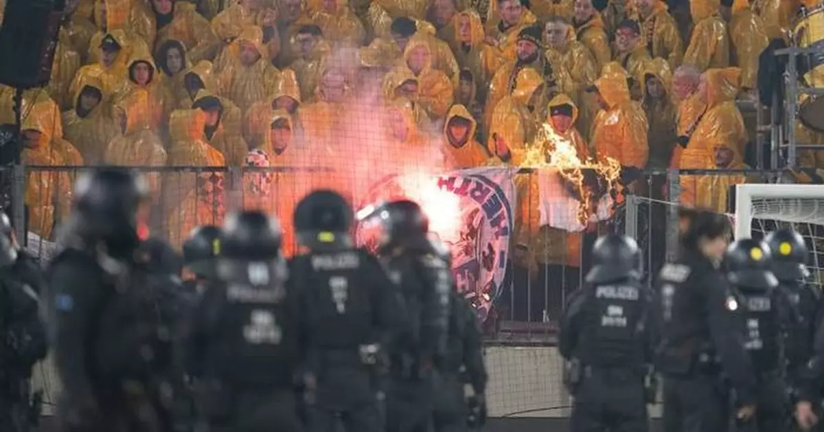 Police chase fans off the field in clashes at German club game in Dresden