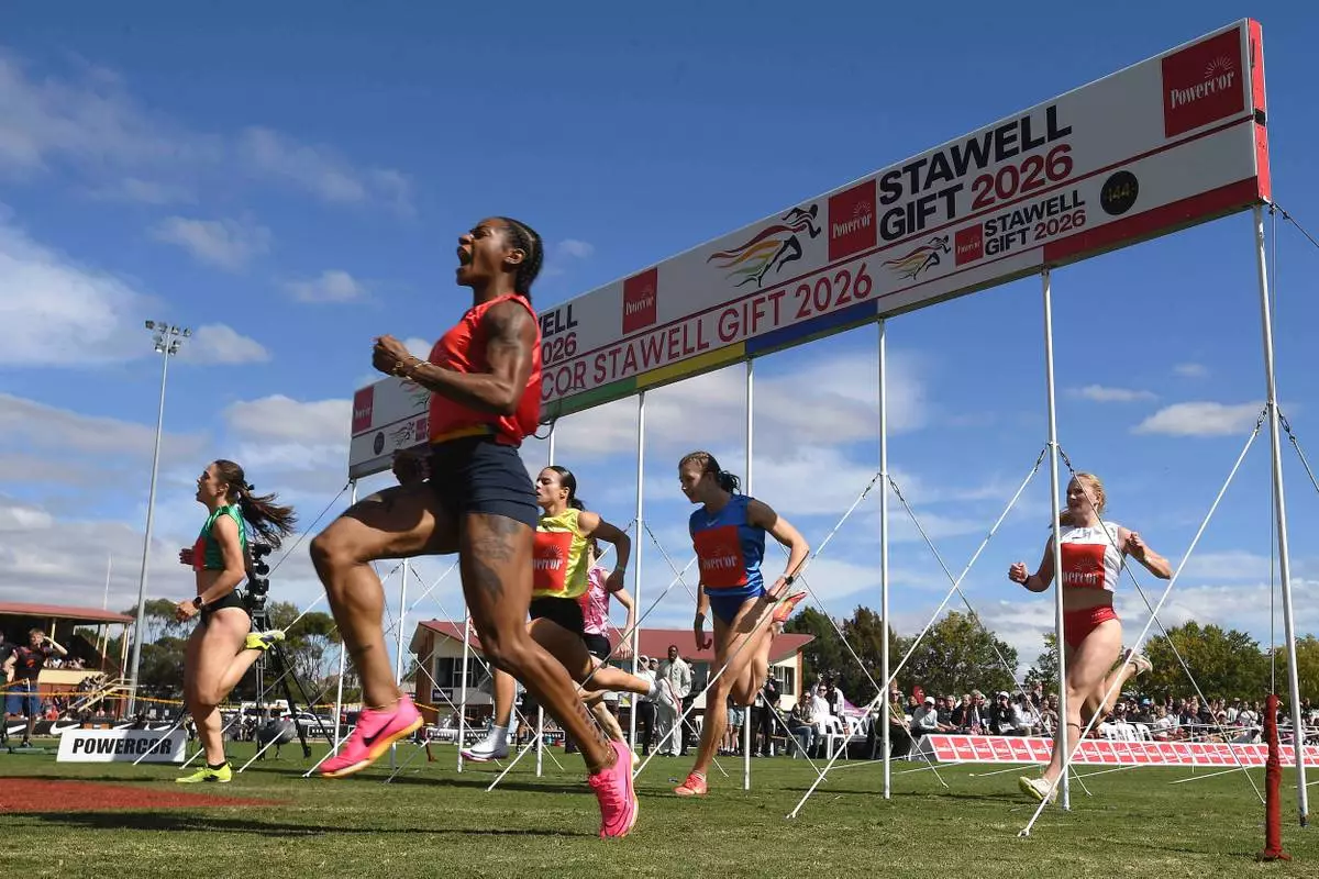 Sha'Carri Richardson of the U.S., second left, celebrates winning the women's Stawell Gift in Stawell, Australia, Monday, April 6, 2026. (Joel Carrett/AAP Image via AP)