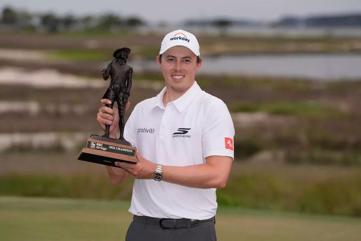 Matt Fitzpatrick, of England, poses with the trophy after winning the RBC Heritage golf tournament Sunday, April 19, 2026, in Hilton Head, S.C. (AP Photo/Mike Stewart)