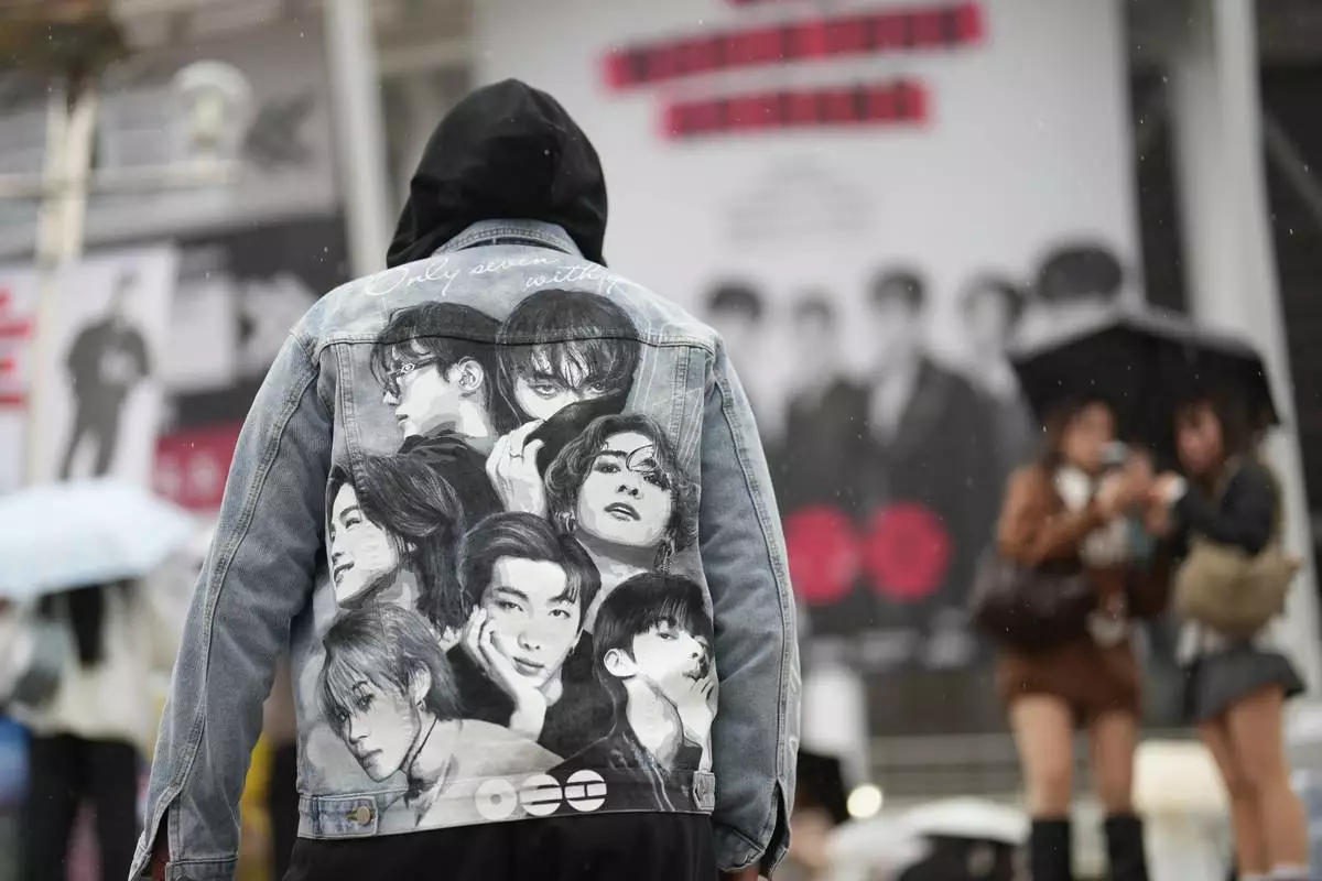 A fan of K-pop band BTS arrives for the BTS World Tour Arirang outside its venue in Goyang, South Korea, Thursday, April 9, 2026. (AP Photo/Lee Jin-man)